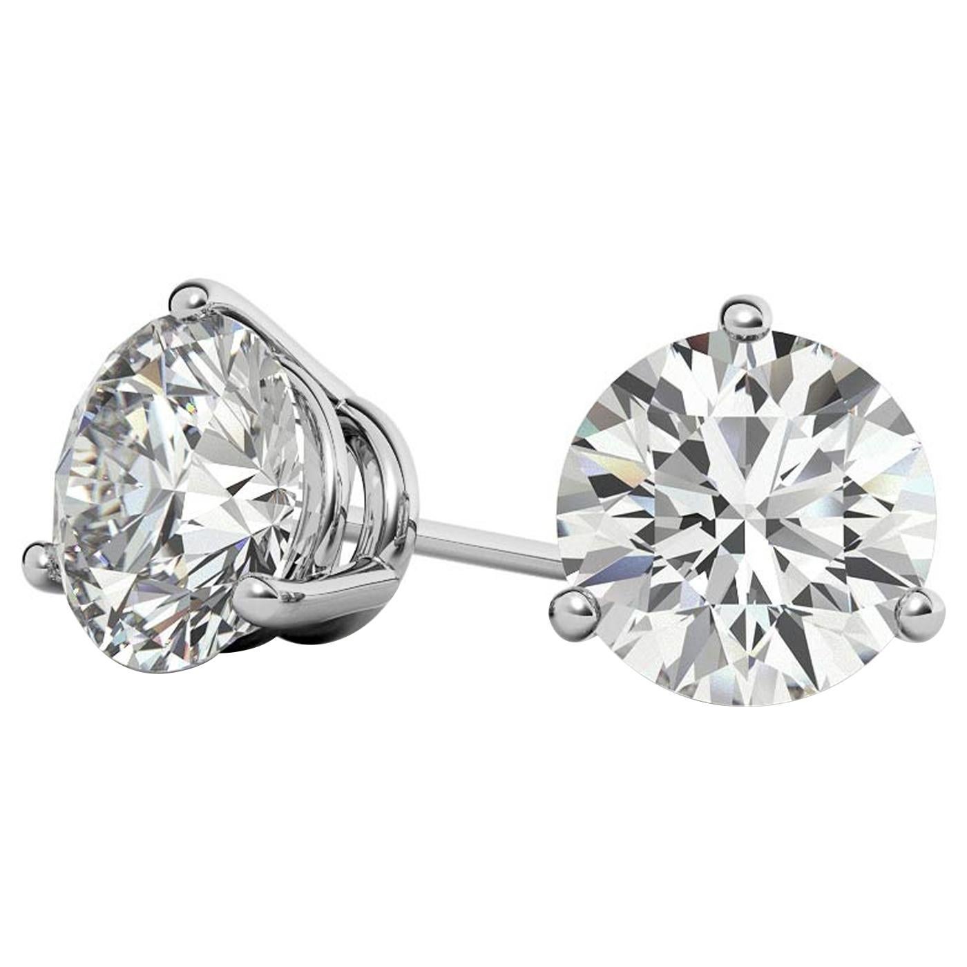 These beautiful natural round stud earrings feature a 3-prong basket design. These earring settings have been specially designed to rest as close to the ear as possible to prevent drooping of the earring. set in 14 Karat white gold. Each three-prong