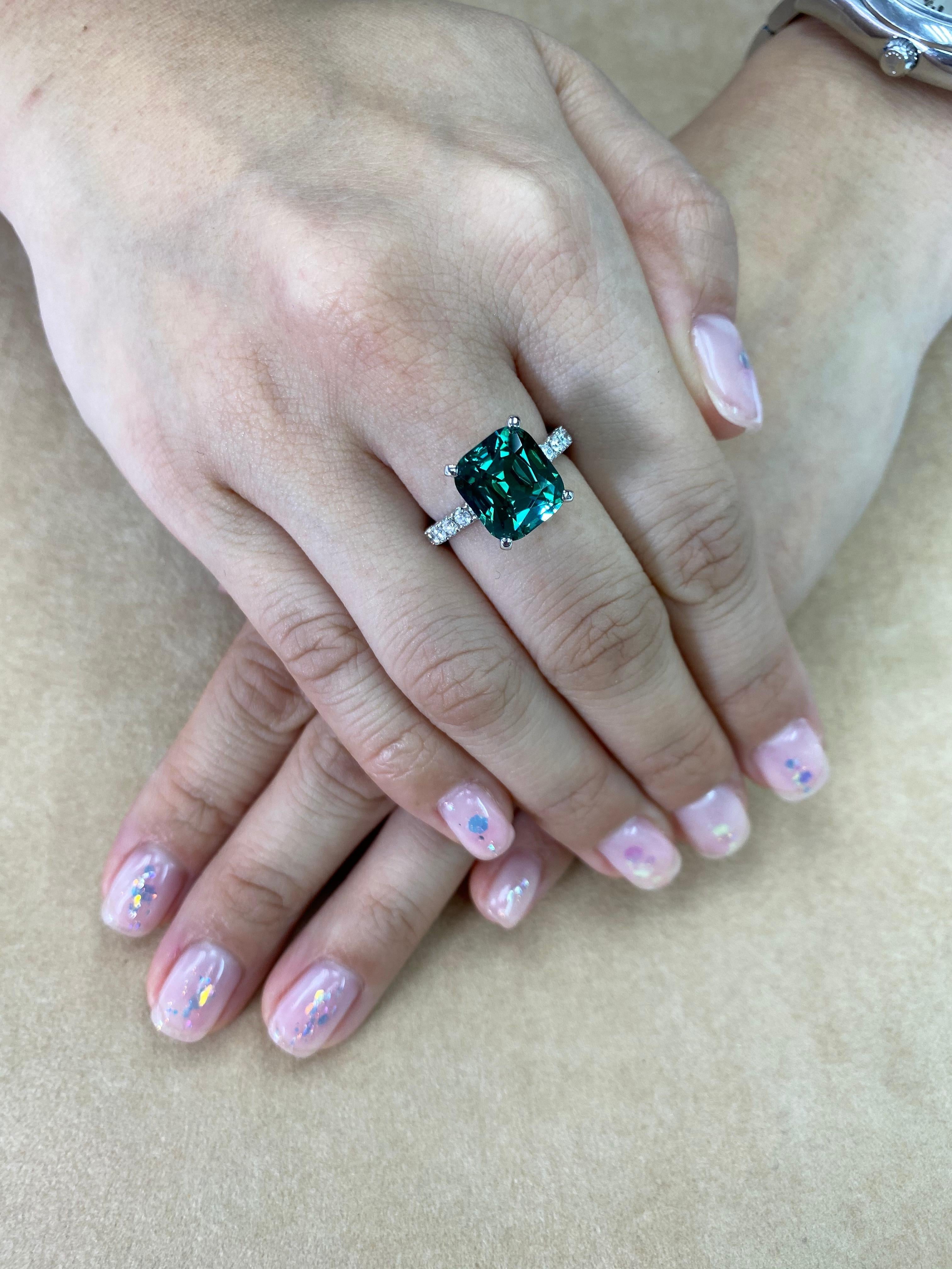 The color is unbelievable! Ask for a video. This is an eye catching piece! Here is a nice natural green tourmaline and diamond ring. The natural tourmaline is full of life. A color that is hard to find and hard to forget. It is not treated or