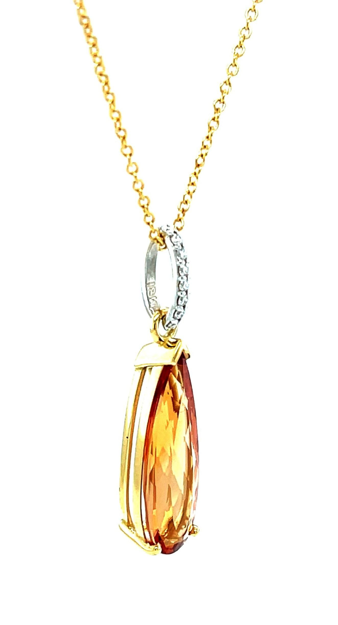 This imperial topaz and diamond drop pendant features a gorgeous 5.56 carat gem-quality precious topaz set in 18k white and yellow gold. The imperial topaz is an elegant, elongated pear shape with exquisite reddish orange color and exceptional