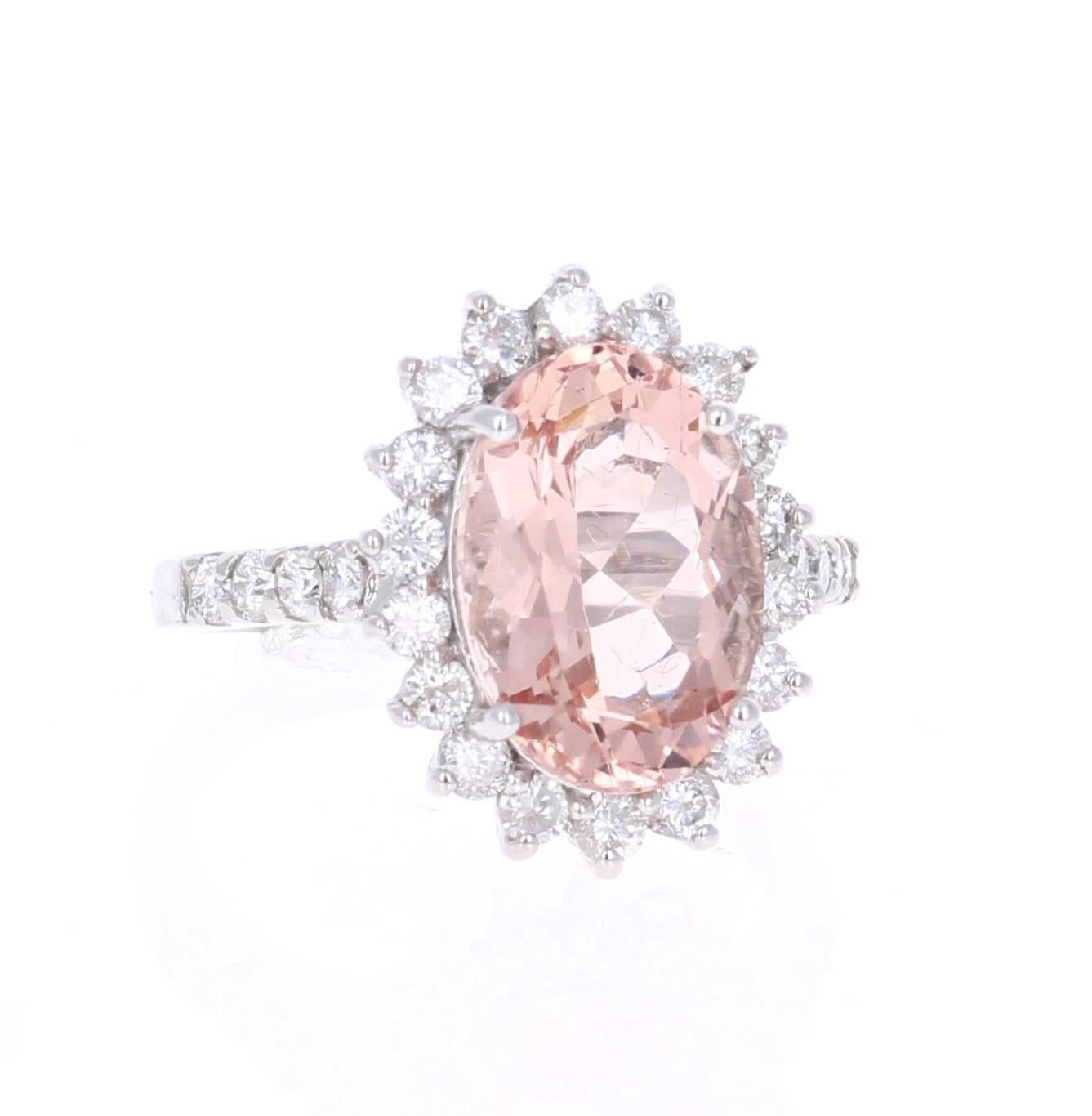 Beautifully set 5.57 Carat Oval Cut Morganite and Diamond Ring in 14K White Gold.   In the center of the ring, there is a 4.62 carat Oval Cut Morganite and is surrounded by 26 Round Cut Diamonds that weigh a total of 0.95 carats Clarity: SI, Color: