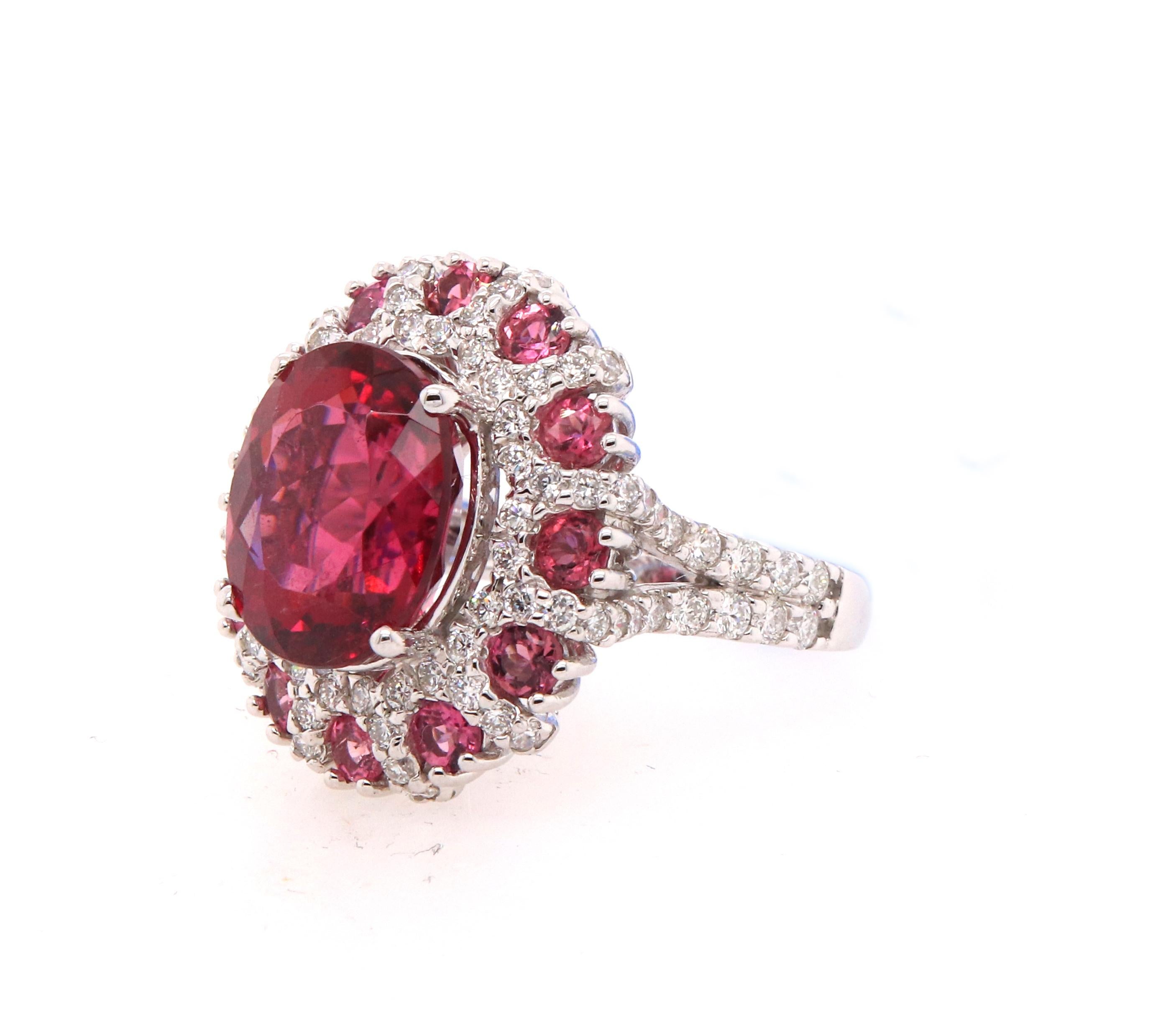 Material: 14k White Gold 
Center Stone Details: 1 Oval Rubellite at 5.57 Carats  - 10 x 11.8 mm
Mounting Stone Details: 12 Round Pink Tourmalines at 0.81 Carats
Diamond Details: 88 Round White Diamonds Approximately 1.16 Carats - Clarity: SI /