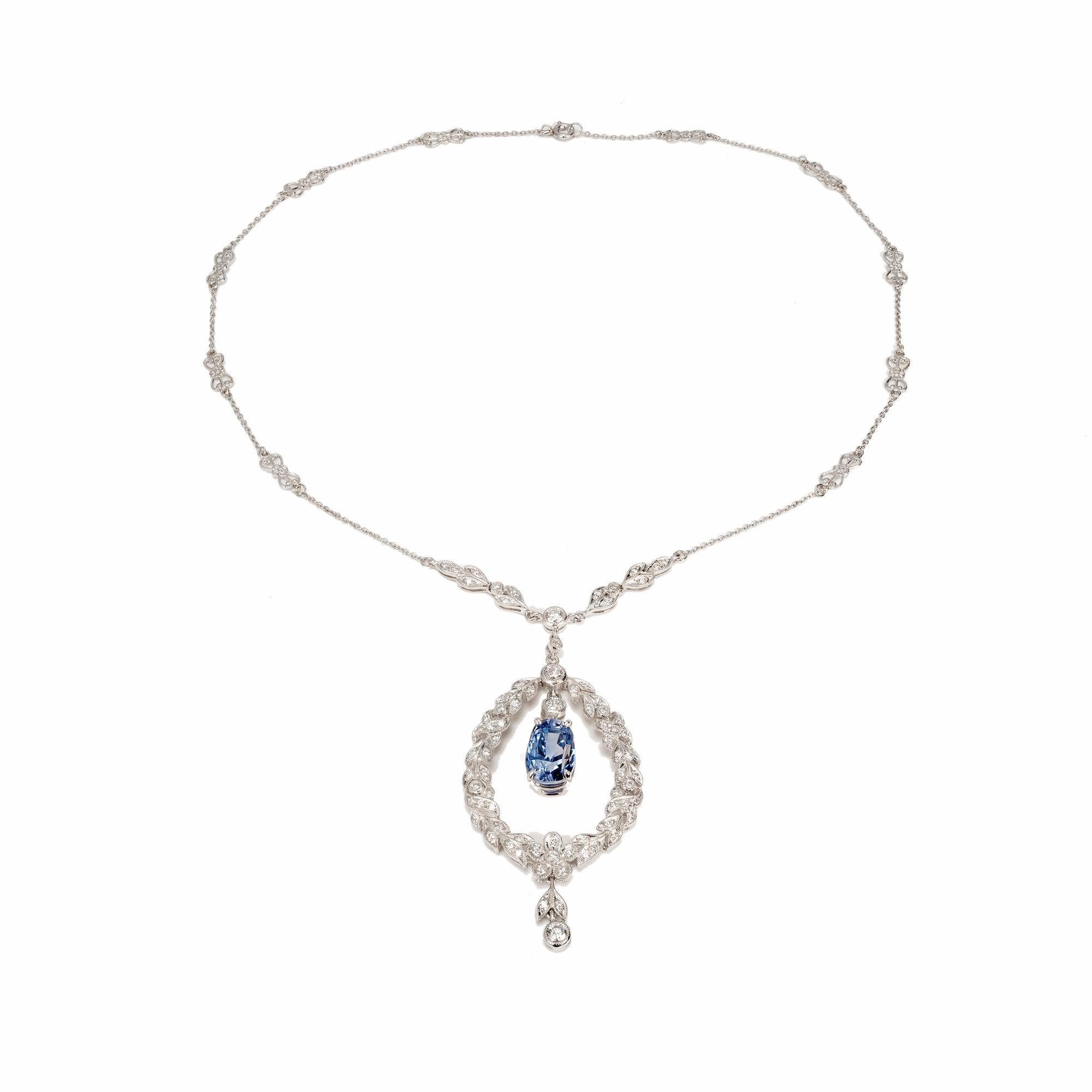 Edwardian sapphire and diamond pendant necklace set with a tapered cushion cut natural periwinkle blue center Sapphire. Platinum chain attached to a wreath with 72 round full cut diamonds. no heat no enhancements. circa 1910

1 oval periwinkle blue