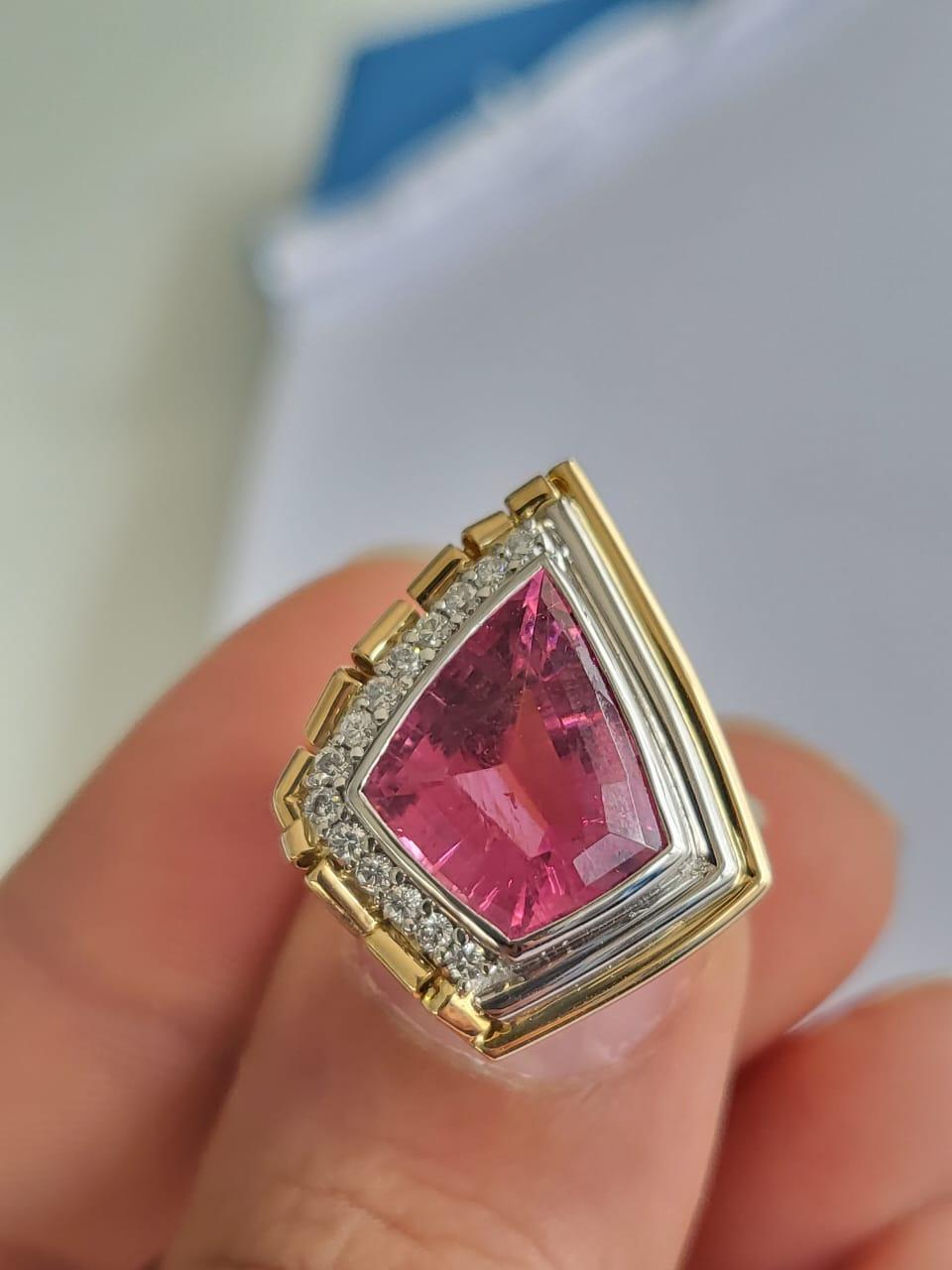 A very gorgeous and one of a kind, Rubellite Cocktail Engagement Ring set in 18K Yellow Gold & Platinum 900. The weight of the shield shaped Rubellite is 5.58 carats. The weight of the Diamonds is 0.19 carat. The combined metal weight is 8.35 grams.