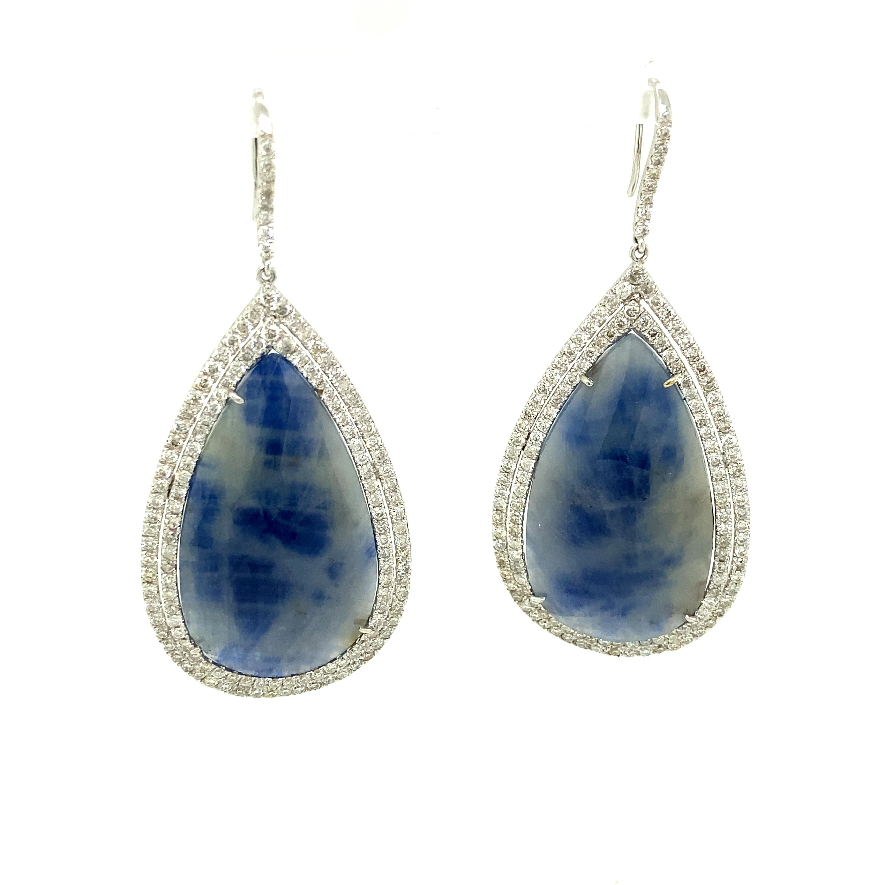 55.84 Carat GRS Certified Unheated White/Blue Sapphire and Diamond Earrings:

An elegant pair of earrings, it features two rose-cut unheated pear shaped blue and white sapphires weighing 55.84 carat along with a halo of white round brilliant