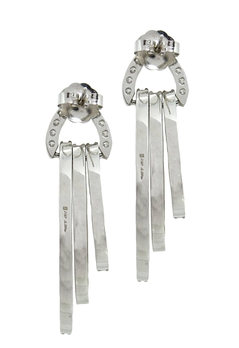 These Chime Like Drop Earrings Are 18K White Gold With a Total Of 126 Sparkling Round Diamonds Weighing A Total Carat Weight Of 5.59 Carats. These Drop Earrings Are About 2 Inches In Length.