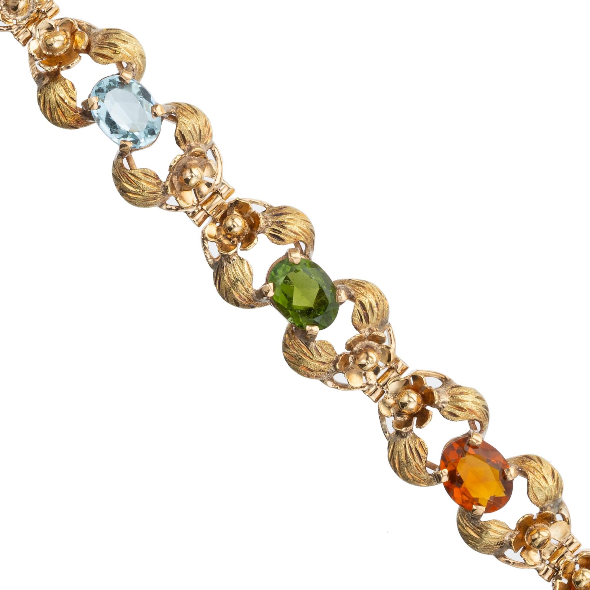 1940's Handmade rose gold multi-stone bracelet. Textured green gold leaves separated by 8 different oval gemstones. Tourmaline, Madera Citrine, Amethyst, Aquamarine and Yellow beryl Heliodore. Beautifully crafted 14k Rose green gold intricate links.