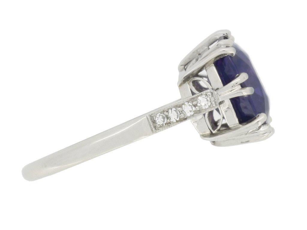 Colour change sapphire ring. Set to centre with a cushion shape old cut natural unenhanced colour change Ceylon sapphire, blue in daylight, purple in incandescent light, with an approximate weight of 5.59 carats in an open back split claw setting,