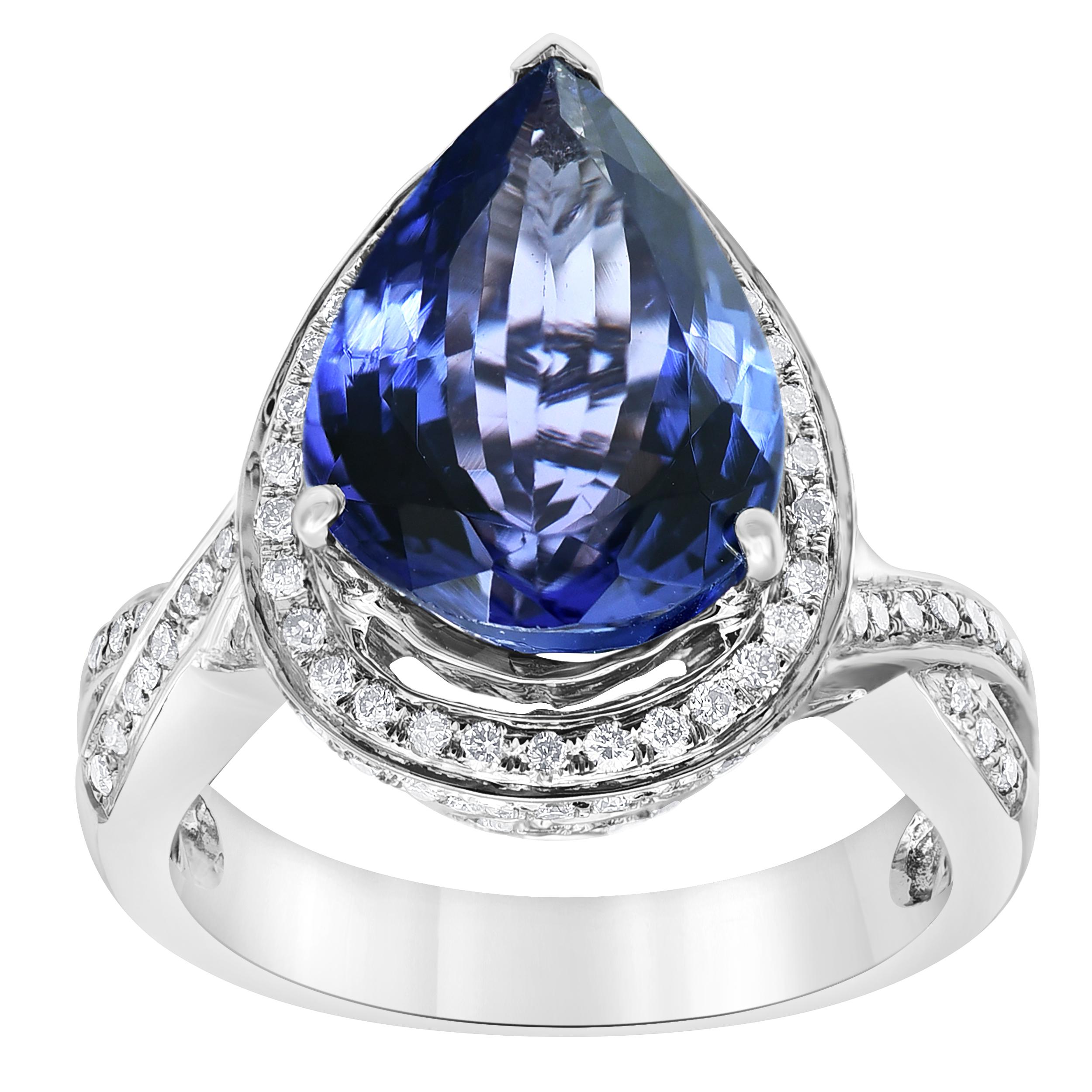 This stunning purplish-blue tanzanite cocktail ring is sure to make jaws drop. The colorful gemstone is surrounded by a glittering halo of pavé-set diamonds in a crown of filigree, all set in bright 14k white gold for a look that is both