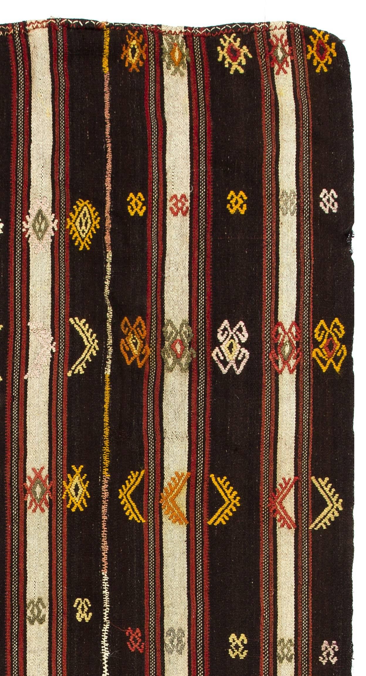 This authentic multifunctional handwoven flat-weave Kilim from Central Turkey was made in mid-20th century by Nomads to be used as a floor covering, bed/bedding cover and a curtain to divide their goat hair tents into two compartments. Measures: 5.5