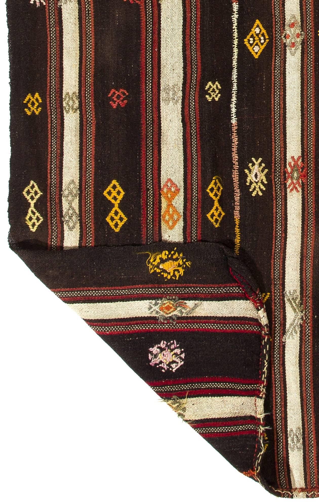 This authentic multifunctional handwoven flat-weave Kilim from Central Turkey was made in mid-20th century by Nomads to be used as a floor covering, bed/bedding cover and a curtain to divide their goat hair tents into two compartments. Measures: 5.5