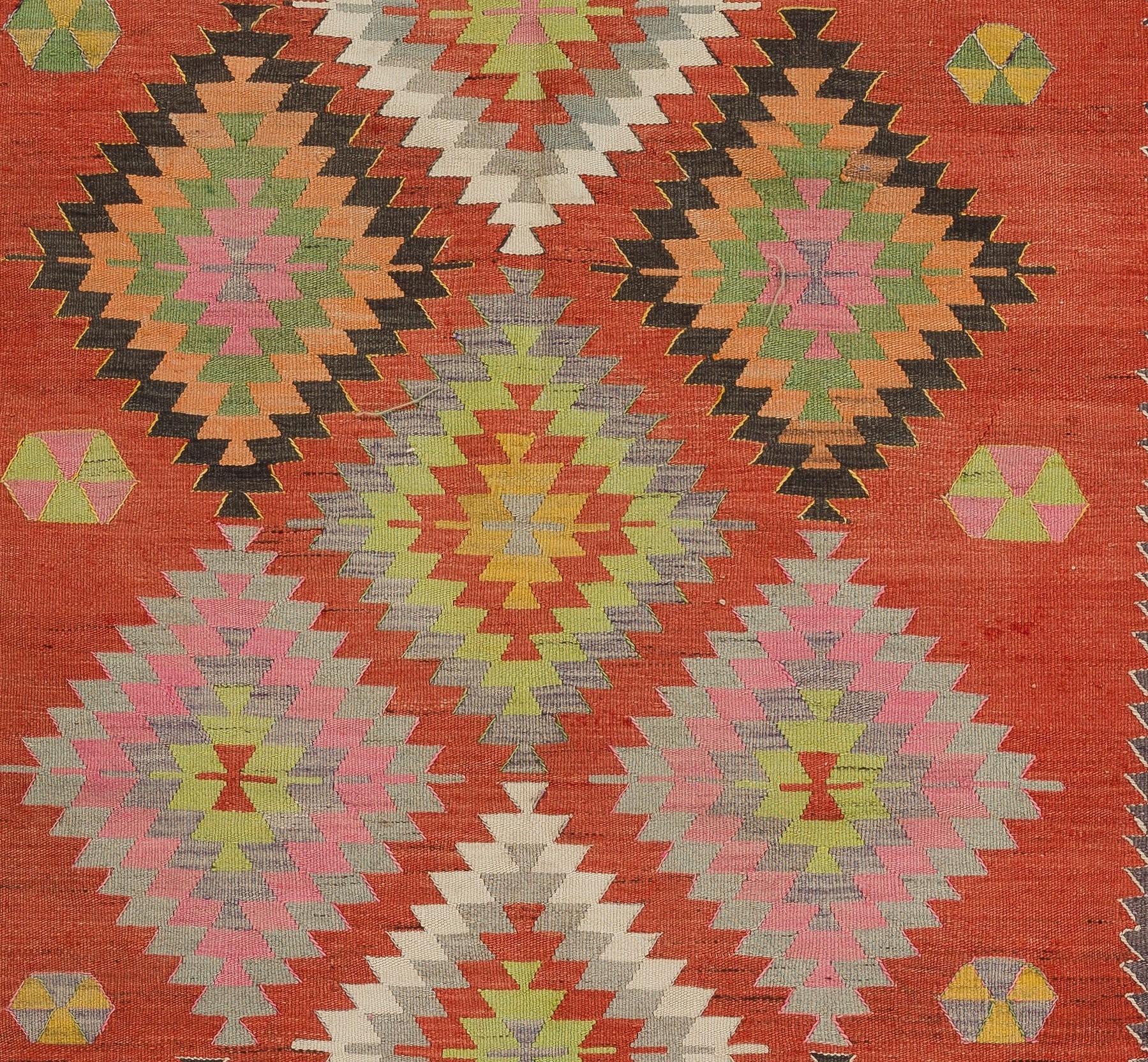 A colorful vintage Turkish Kilim. A flat-weave rug made completely of wool in excellent condition. 

This captivating Kilim features stepped diamond patterns nestled within each other, free-floating all-over the field in varying sizes and a large