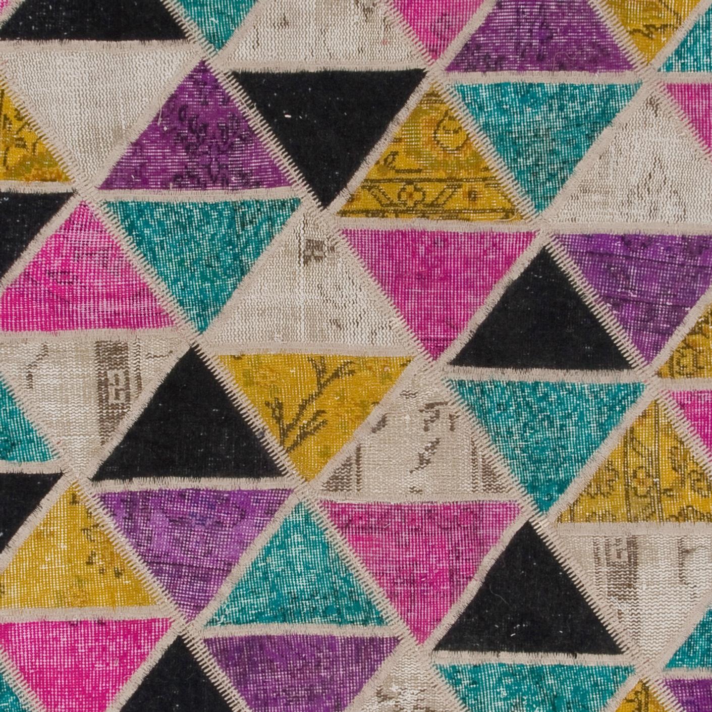 Assorted pieces of mid-20th century hand knotted woolen Anatolian rugs were washed, sheared, redyed in various colors, cut into small rectangles then stitched together by hand in couple of weeks to create this beautiful one of a kind patchwork rug.