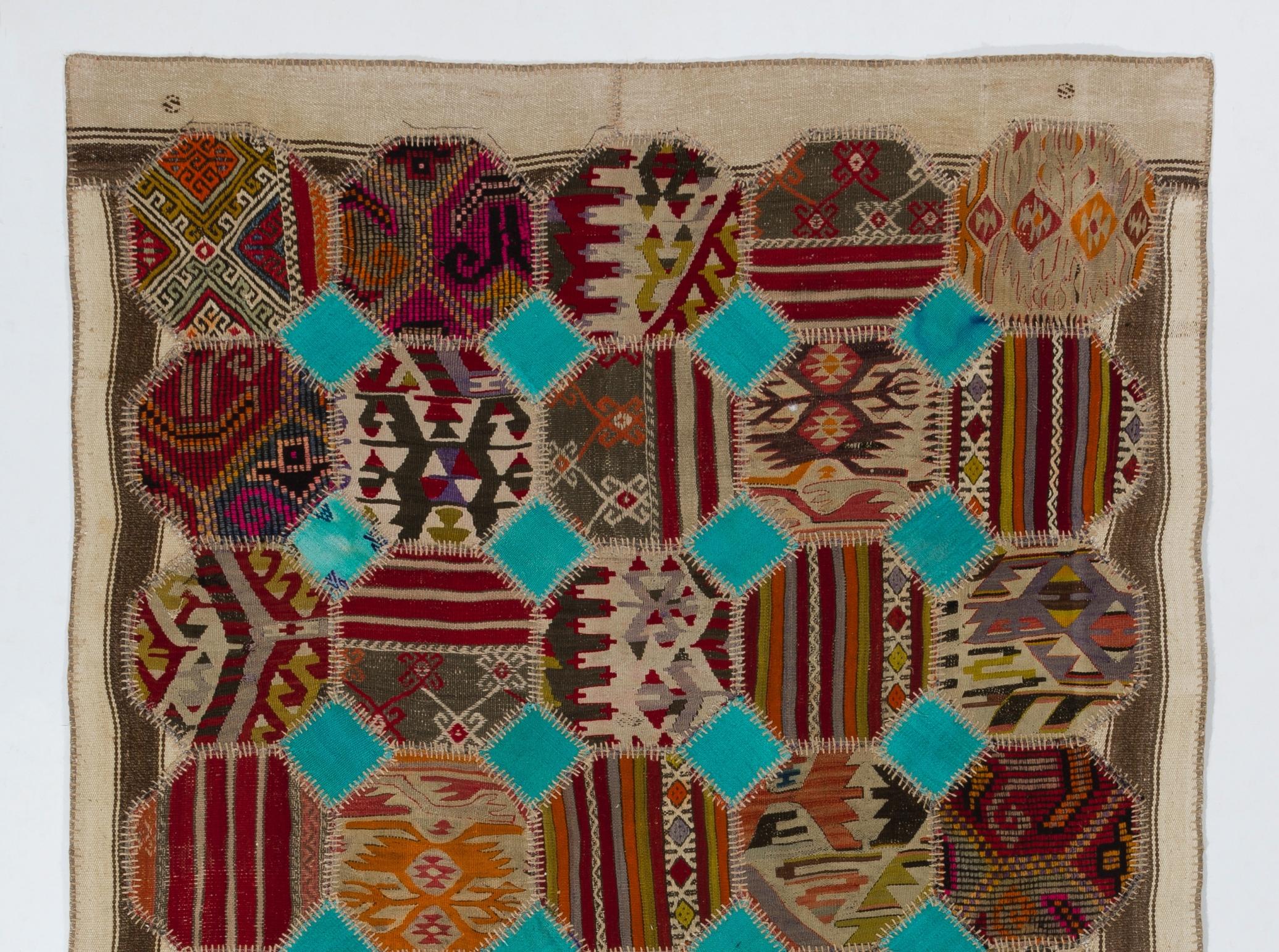 This floor covering is made of pieces of assorted vintage handmade Anatolian kilims. Washed professionally. Made of wool and cotton. There is a durable cotton twill sewn on the back as an underlay and for a smooth finishing. Measures: 5.5 x 8.7 ft.