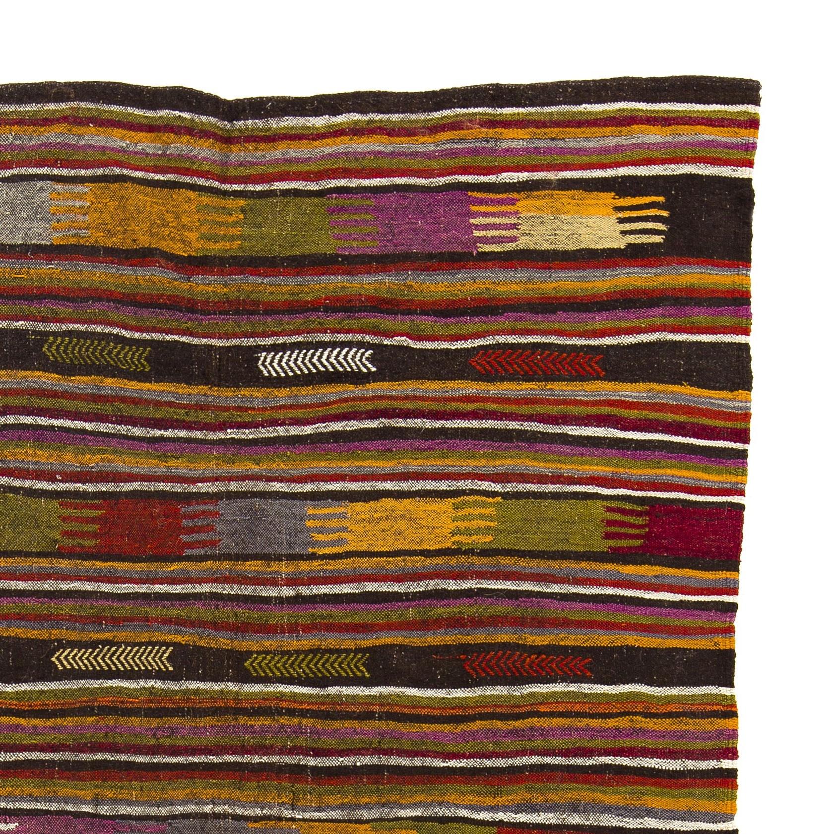 A colorful handwoven vintage nomad Kilim rug from the south of central Anatolia made of natural organic wool and goat's hair. In very good condition, sturdy and clean. Measures: 5.5 x 9.2 Ft.

This nomad Kilim is a pleasure to look at. Its
