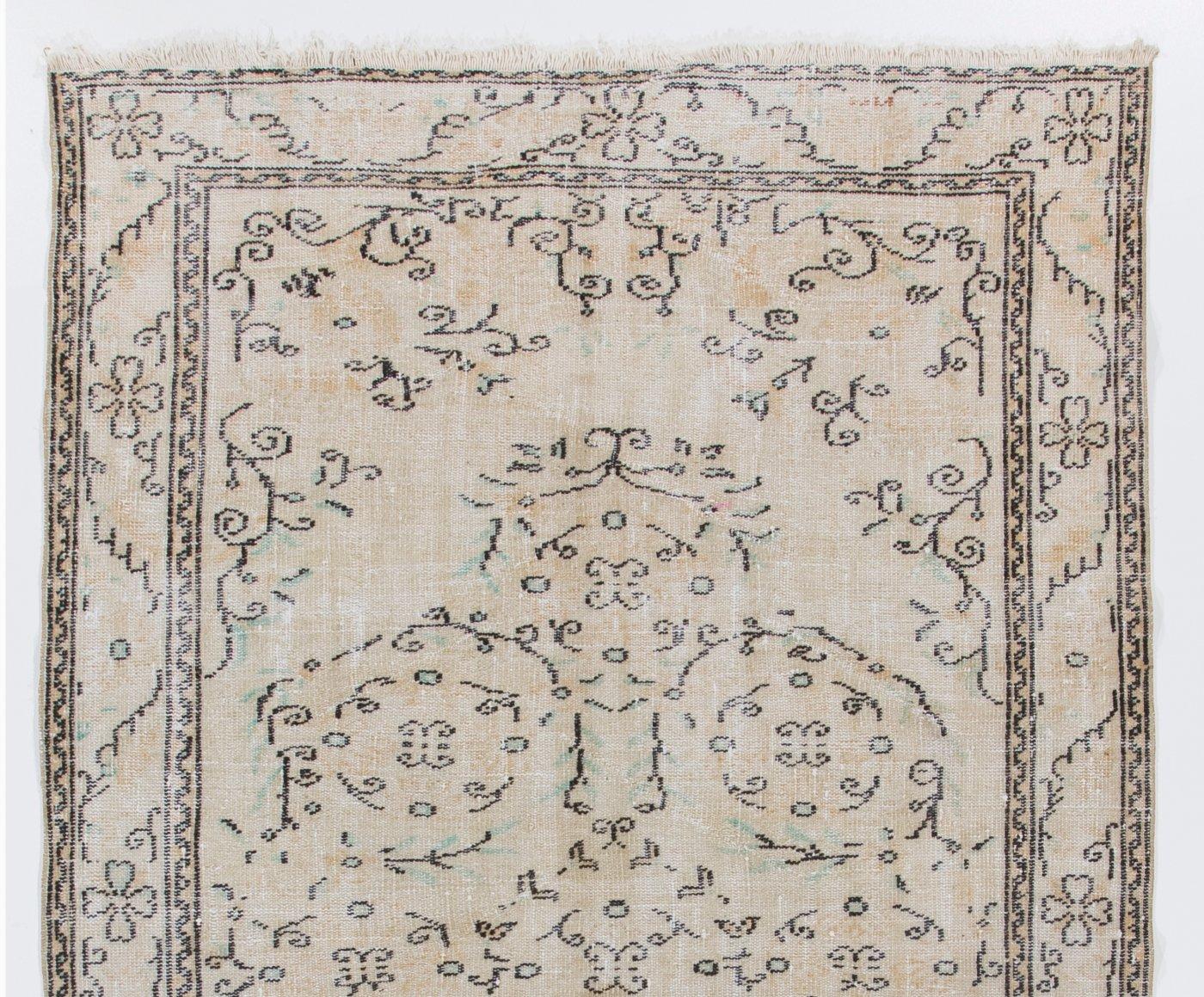 A finely hand-knotted vintage Turkish carpet from 1960s featuring an elegant medallion design. The rug has even low wool pile on cotton foundation. It is heavy and lays flat on the floor, in very good condition with no issues. It has been washed