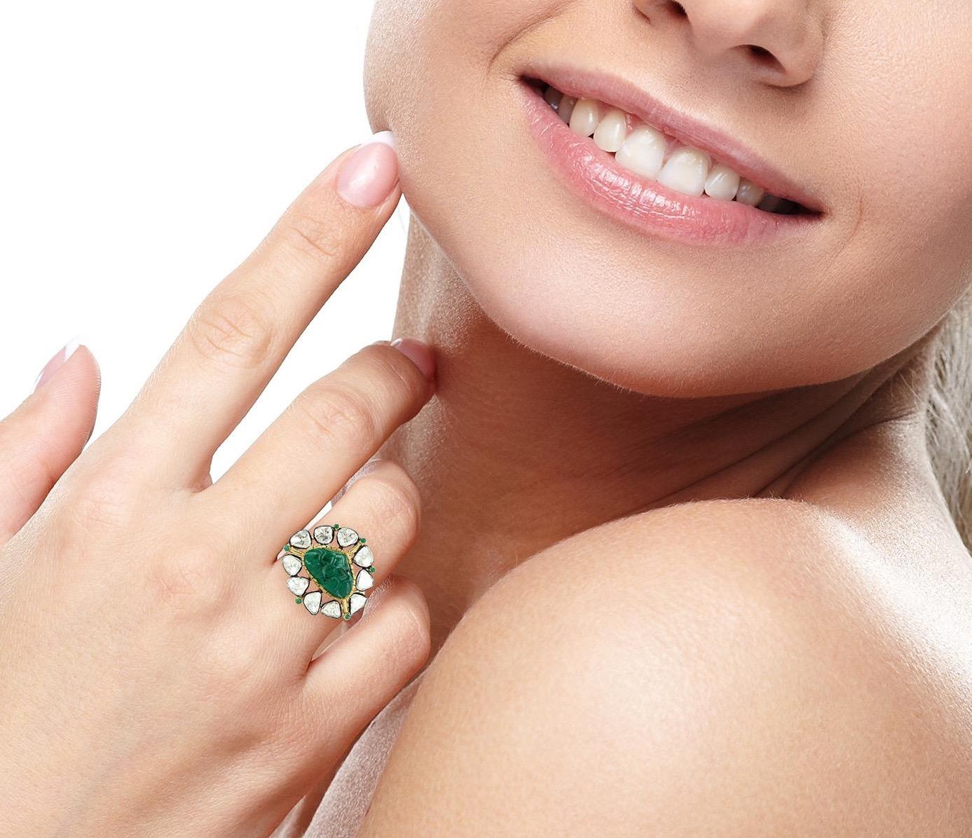 This ring has been meticulously crafted from 18-karat gold & sterling silver. Handcrafted in 5.6 carats Carved emerald & illuminated with 2.6 carats rose cut diamonds. 

The ring is a size 7 and may be resized to larger or smaller upon request.