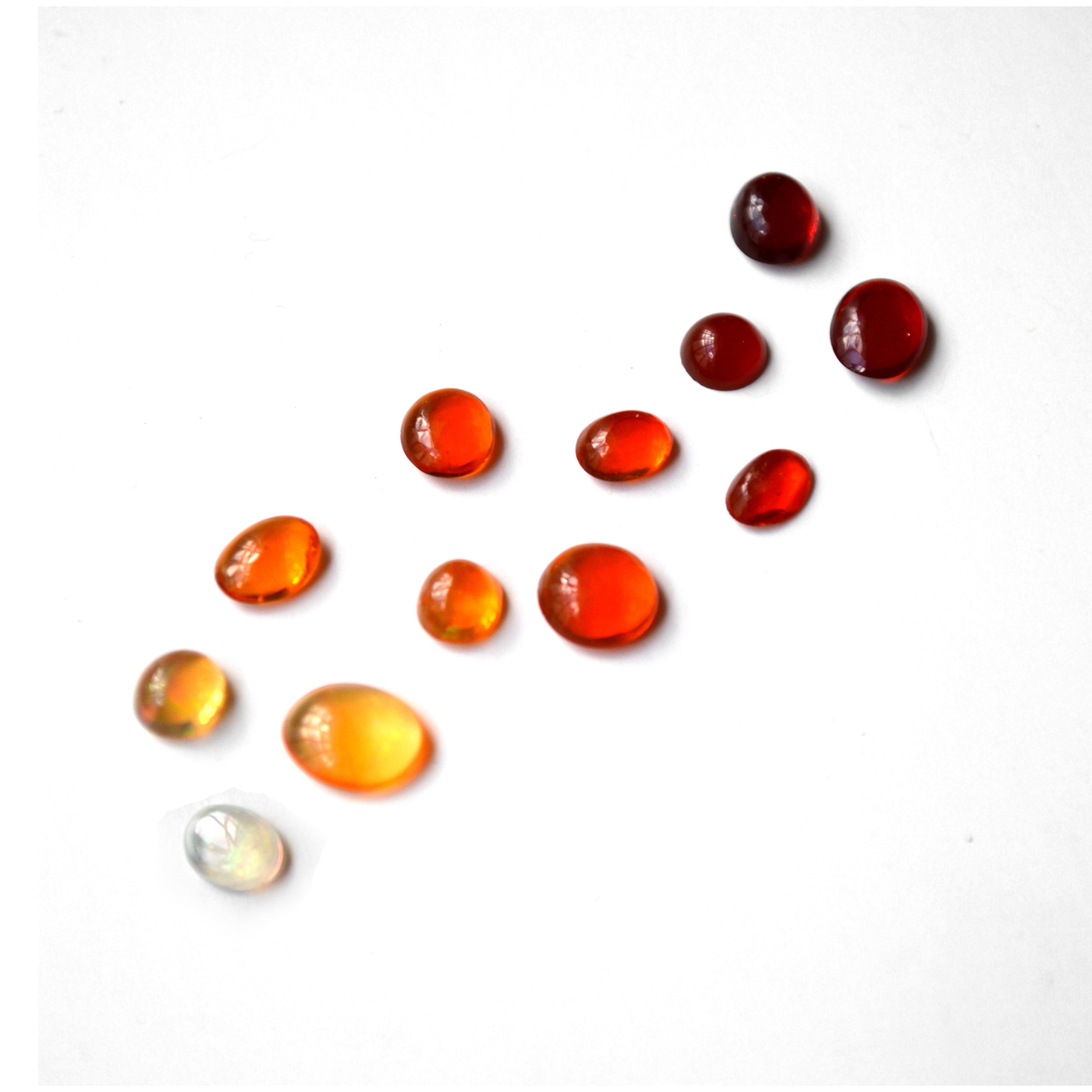 Lot of Loose Gemstones (12 pieces)
5.60 Carat in total 
Cabochon cut stones
Fire Opal
Different colored opals, ranging from red, orange and yellow.

The biggest stone has the dimentions:
6.5 x 8 x 2.3 mm 
The smallest stone has the dimentions:
4.2 x
