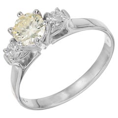 Anillo de compromiso de oro de tres piedras con un diamante amarillo claro de fantasía redondo de 0,56 quilates