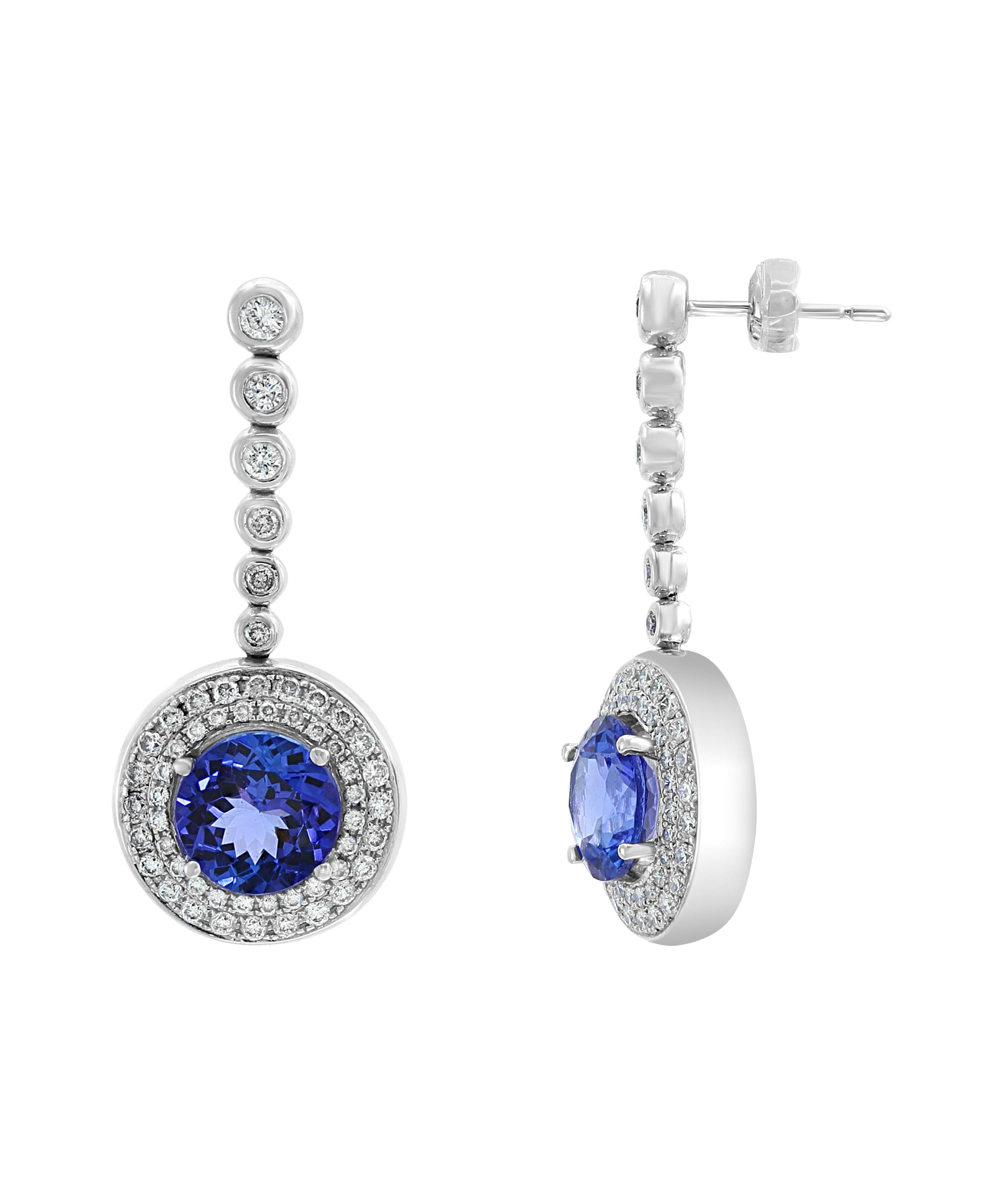 5.6 Carat  Round Tanzanite and Diamond Hanging or Cocktail Earring 18 Karat White Gold
perfect pair made in  18 carat White gold . 
18 K gold :13 Grams
 Diamonds: approximate 1.8 carats
Tanzanite: 5.6Carats
Its very hard to capture the true color