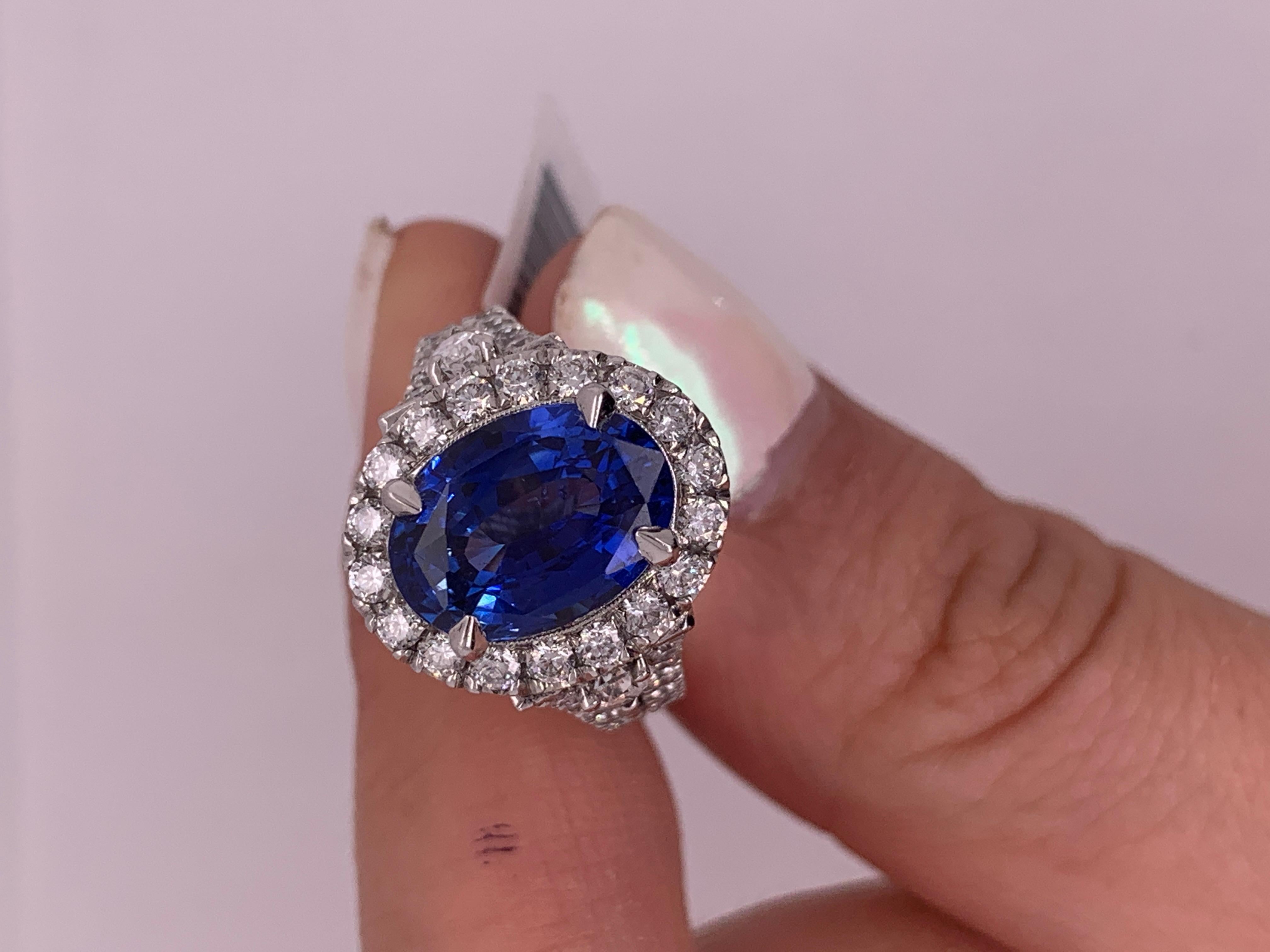 18 Karat White Gold Blue Sapphire Diamond Ring, features 5.60 Oval Shape Sapphire and 2.60 Carat of Micropave Round Diamonds and Two Pear Shape Diamond Set In Filigree Diamonds Splitted Setting. Ring comes in 5.5 size, but could be resized upon your