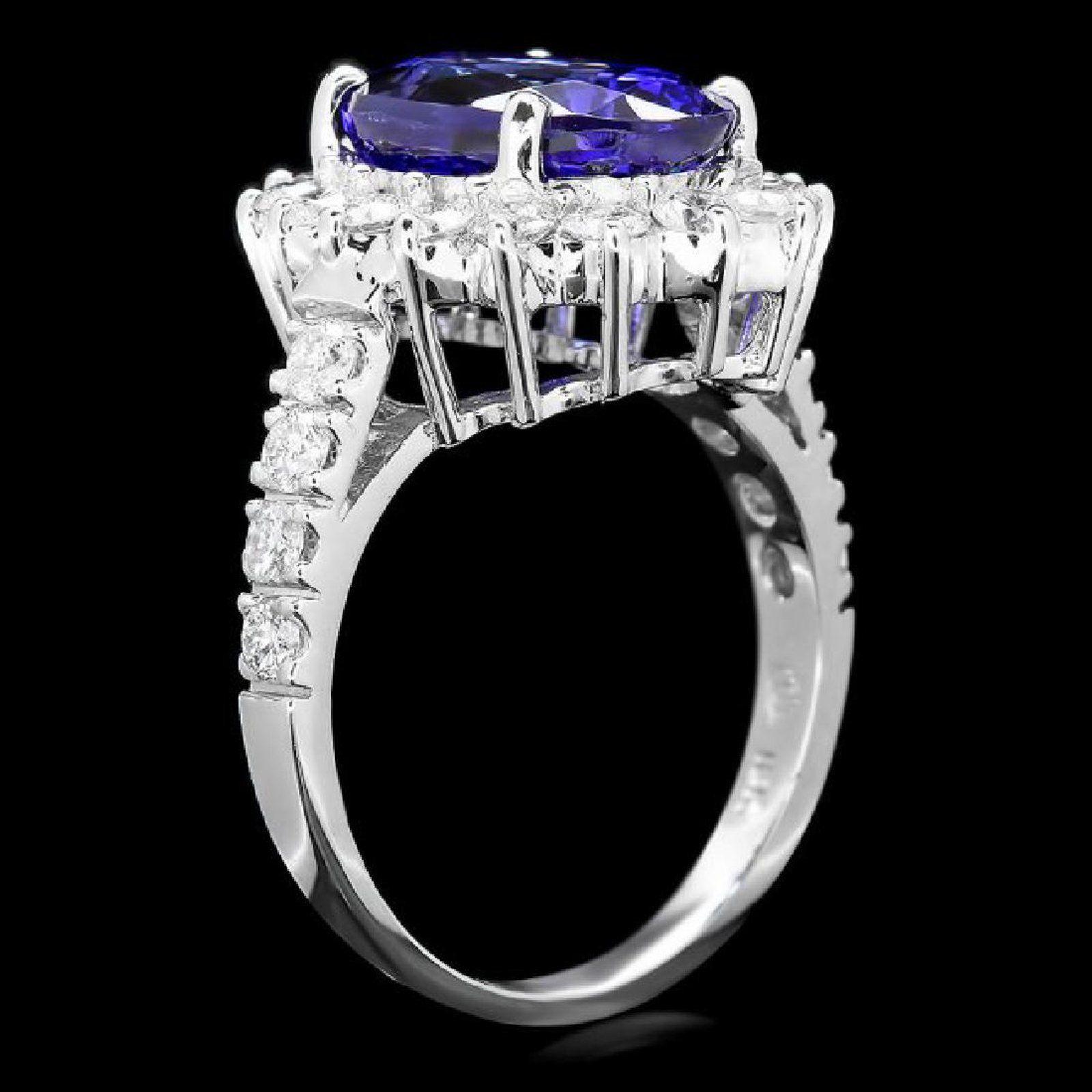 5.60 Carats Natural Very Nice Looking Tanzanite and Diamond 14K Solid White Gold Ring

Total Natural Cushion Cut Tanzanite Weight is: Approx. 4.50 Carats

Tanzanite Measures: Approx. 11.00 x 9.00mm

Natural Round Diamonds Weight: Approx. 1.10 Carats