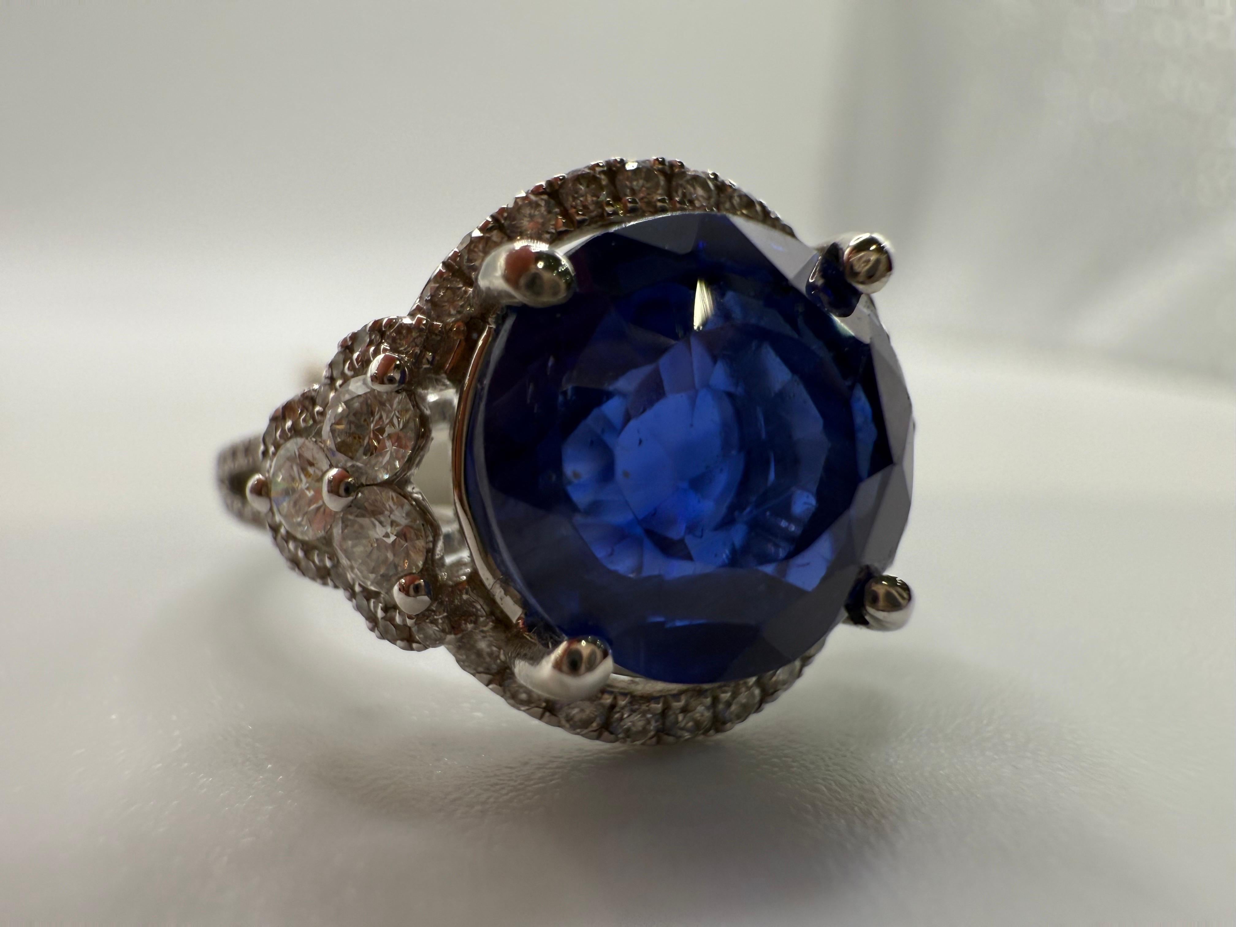 Huge center sapphire unheated and certified by GIA totaling 5.60 carats accompanied by 0.27 carats of diamonds in 18KT white gold cathedral setting. Ring is 6.5 and can be re-sized.

**All items leave our premises with a certificate in buyers name,