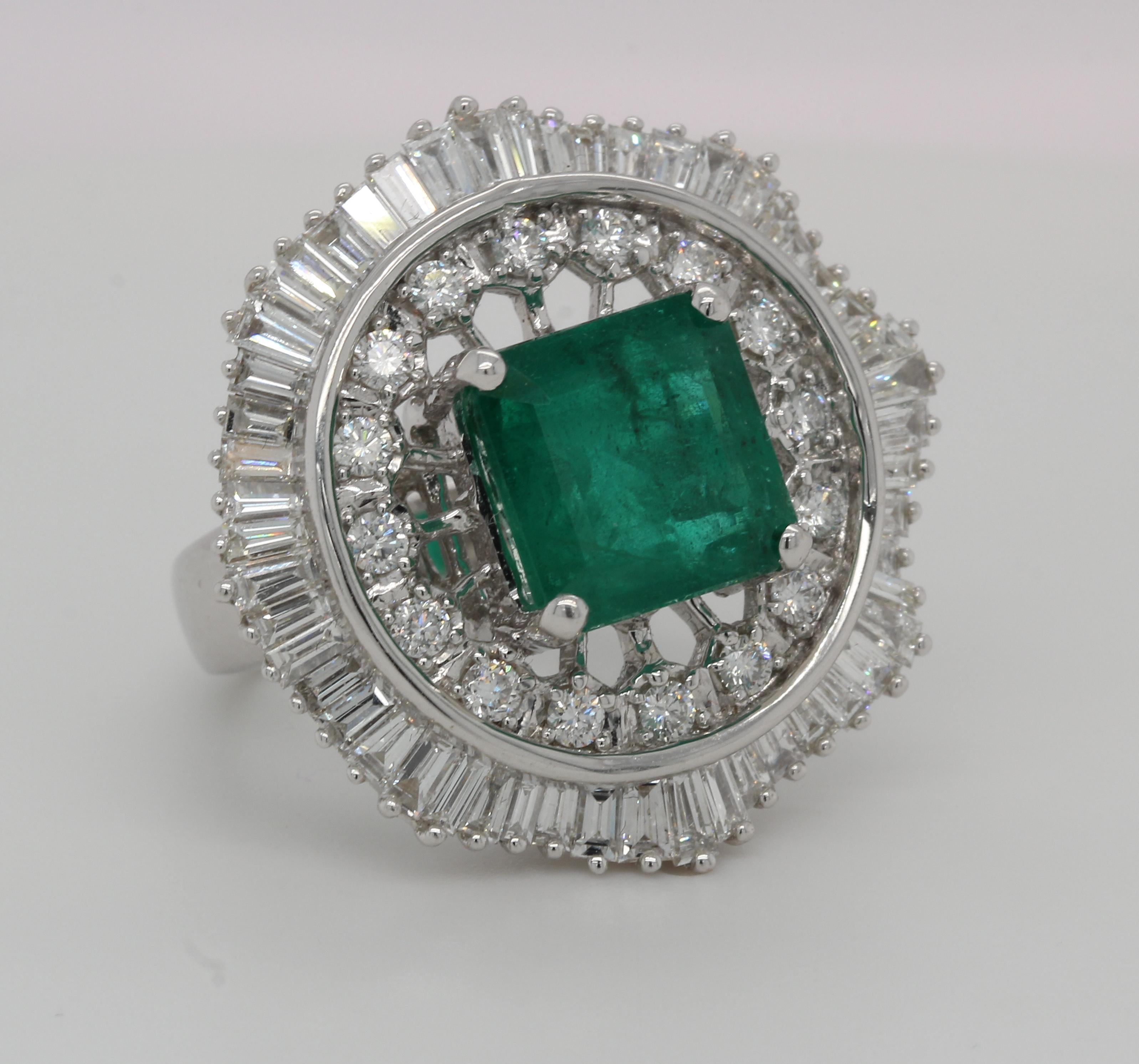 A brand new emerald and diamond ring in 18K gold. A 5.61 carat emerald cushion is set in the center of this ring, which is surrounded by 2.16 carat diamond tapper and 0.56 carat diamond round. This ring weighs 15.94 grams and is made of 18K white