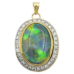 5.62 Carat Oval Cut Opal and Diamond Halo Pendant in 14 Karat Yellow Gold