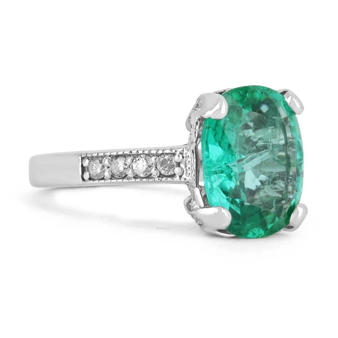 Featured here is a stunning emerald and diamond engagement/anniversary ring. The center stone holds 5.12-carats of pure natural beauty. The stone displays a lovely shine and green color, as well as very good eye clarity. Accented on both sides are
