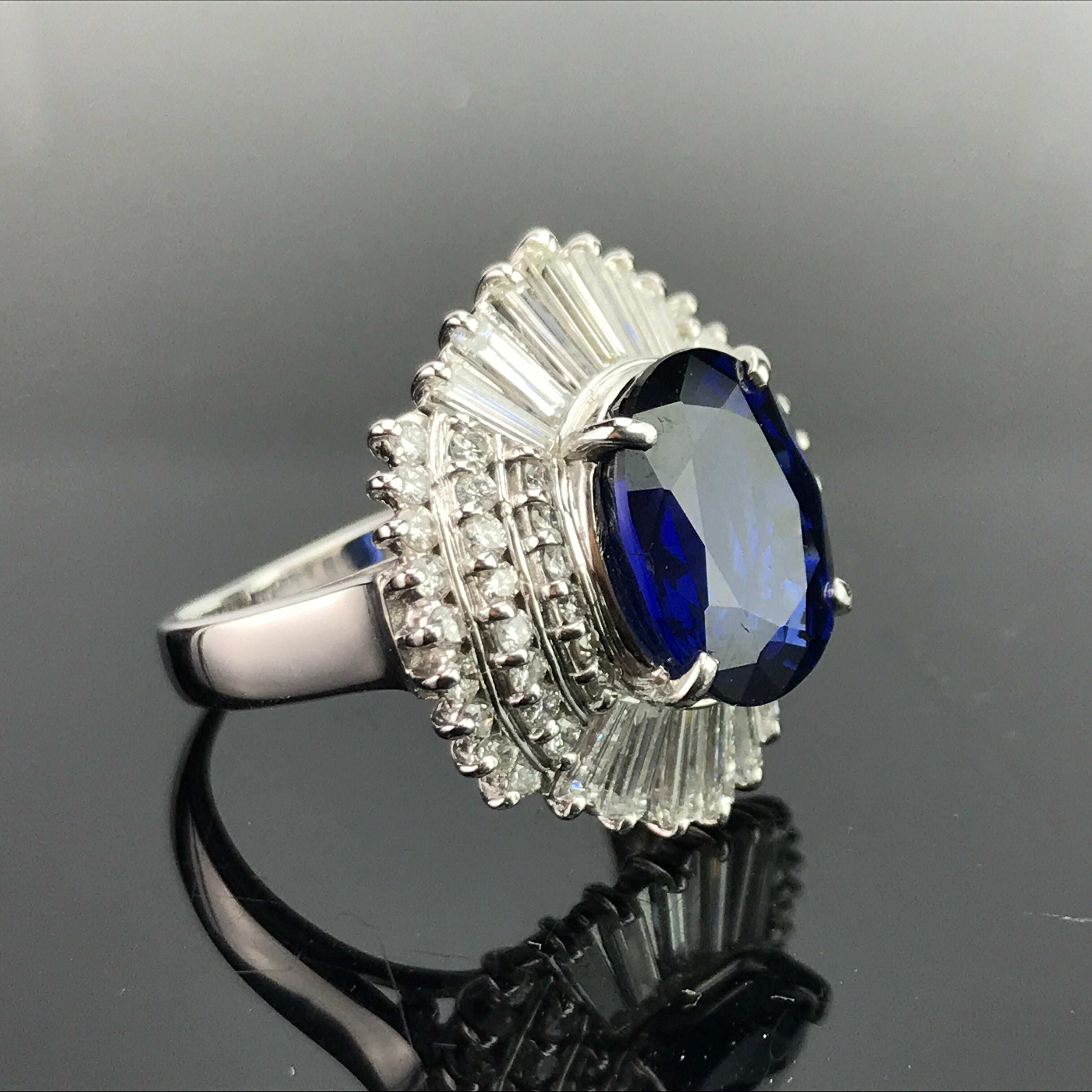 A beautiful, art-deco looking cocktail ring with 5.63 carat eye-clean, lustrous, Ceylon Blue Sapphire sorrounded by 1.69 carat White Diamond baguettes and brilliant cut, all set in platinum. 

Stone Details: 
Stone: Blue Sapphire
Cut: Oval
Carat