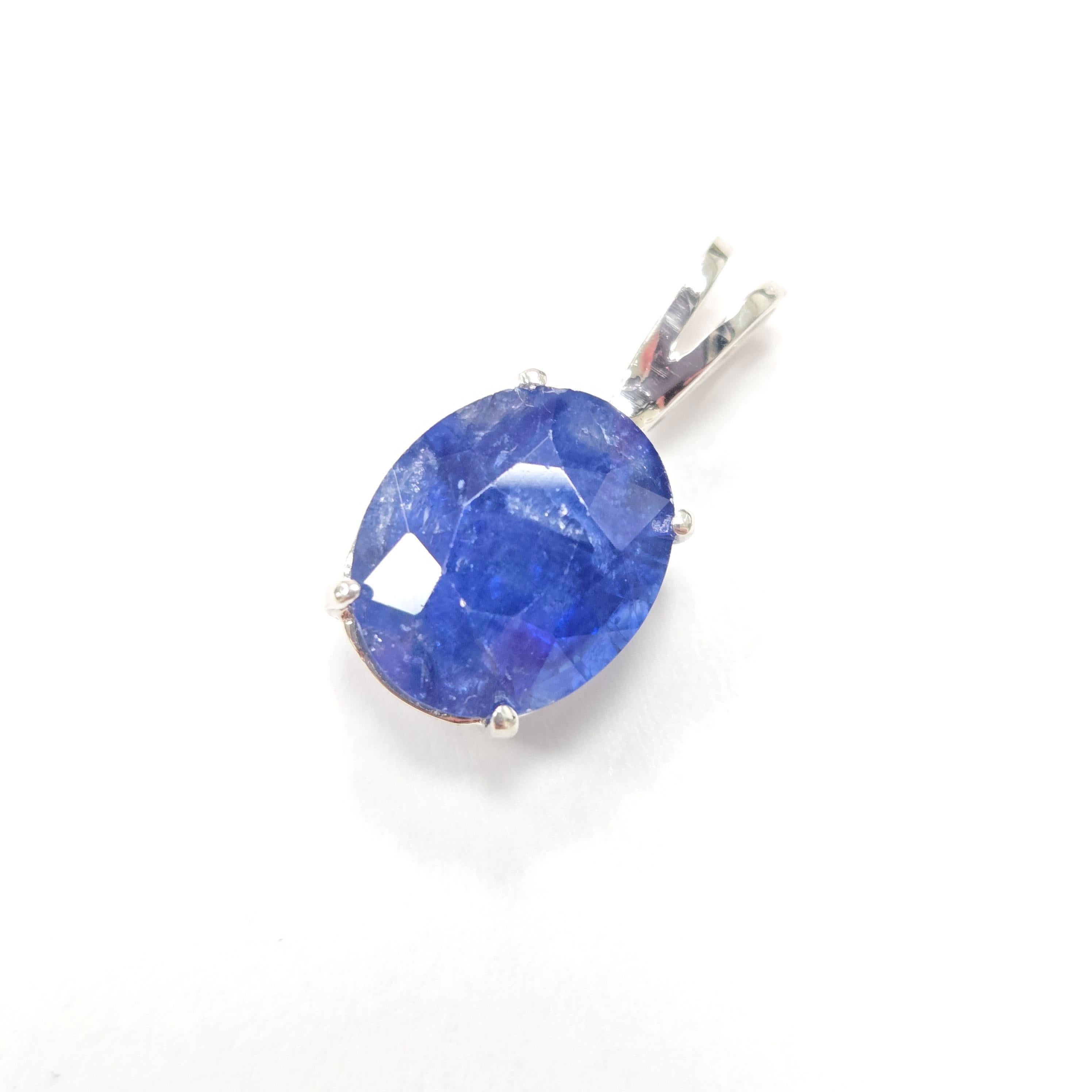 A timeless and elegant piece, this exquisite pendant showcases a 5.63 carat natural sapphire, masterfully cut in a classic oval shape. The gemstone’s rich hue is beautifully complemented by a refined 14k white gold setting, allowing the sapphire’s