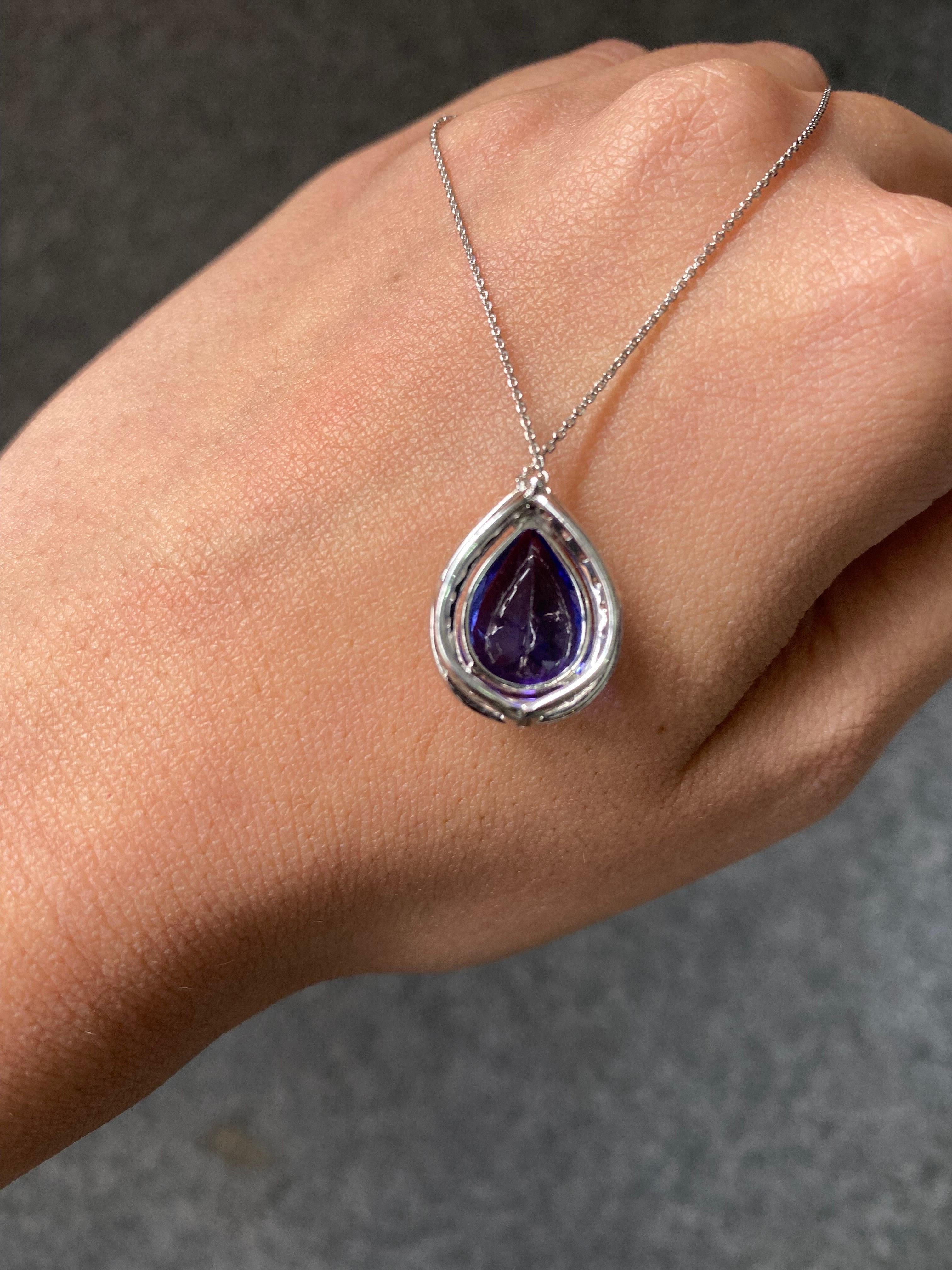An elegant 5.63 carat natural pear shape Tanzanite pendant, with an ideal blue color,  AAA quality stone. The centre stone has no inclusions, and is absolutely transparent with great luster. The VS quality diamonds and Tanzanite are set in solid 18K