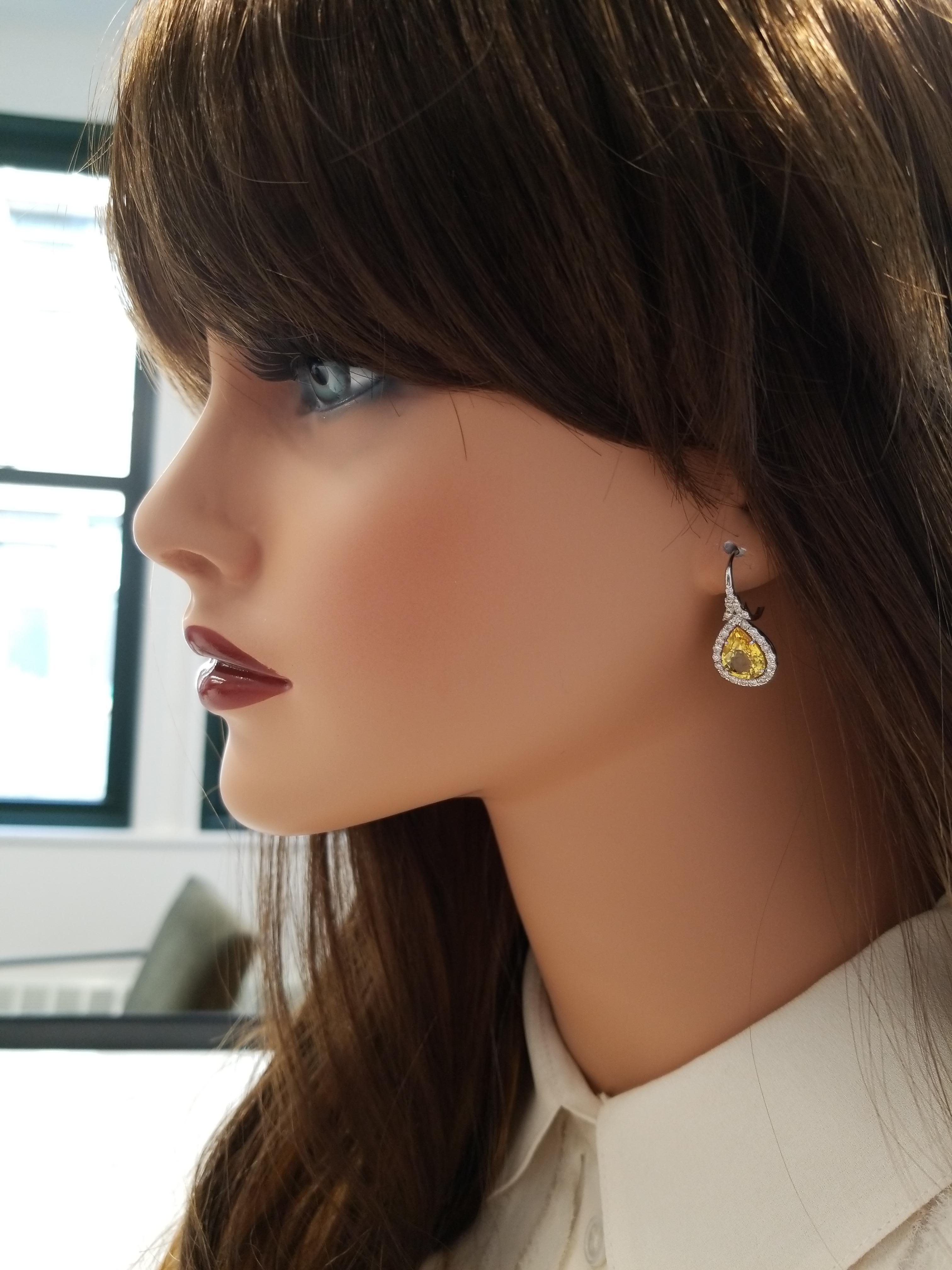 The earrings feature 5.63 carat total weight of illuminating lemon-yellow sapphires. The perfectly matched pear shaped gems are from Sri Lanka. These yellow sapphires are extremely high in purity and transparency. The color is evenly distributed, a