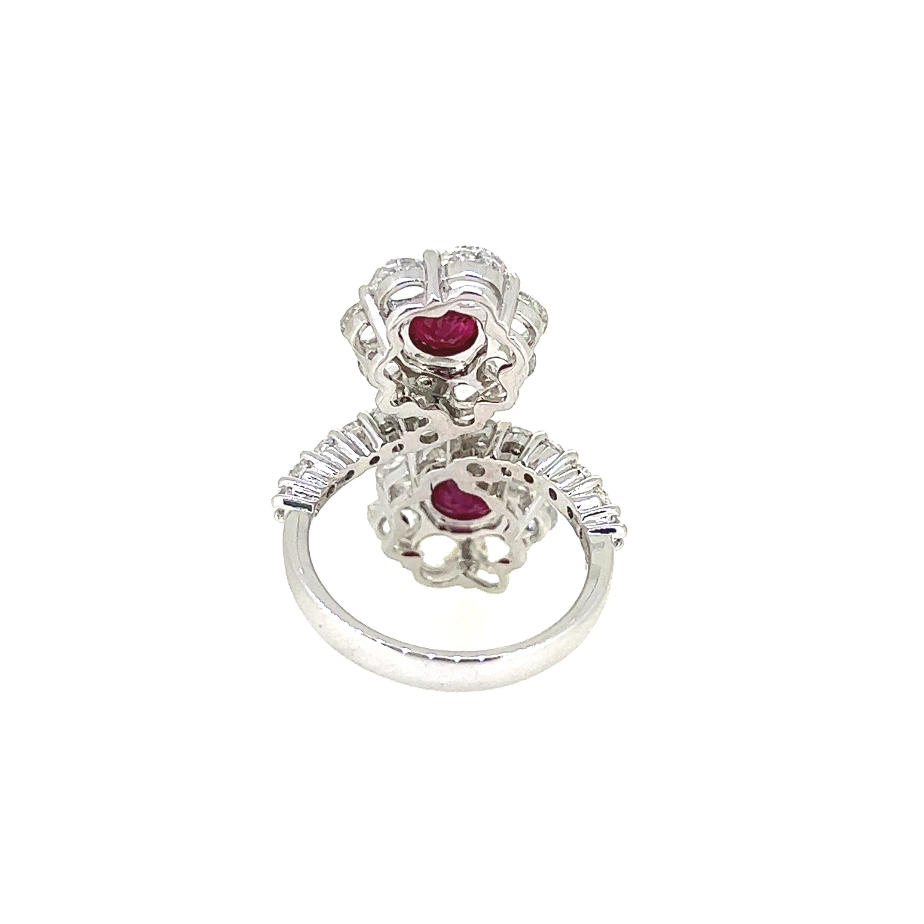 This extraordinary Double Flower Ring boasts sparking pair of Ruby set as center stones weighing 2.48 carats surrounded by 28 Rose cut Diamonds weighing 3.15 carats.  Crafted in 18 Karat White Gold, this beautifully designed ring sparkles with