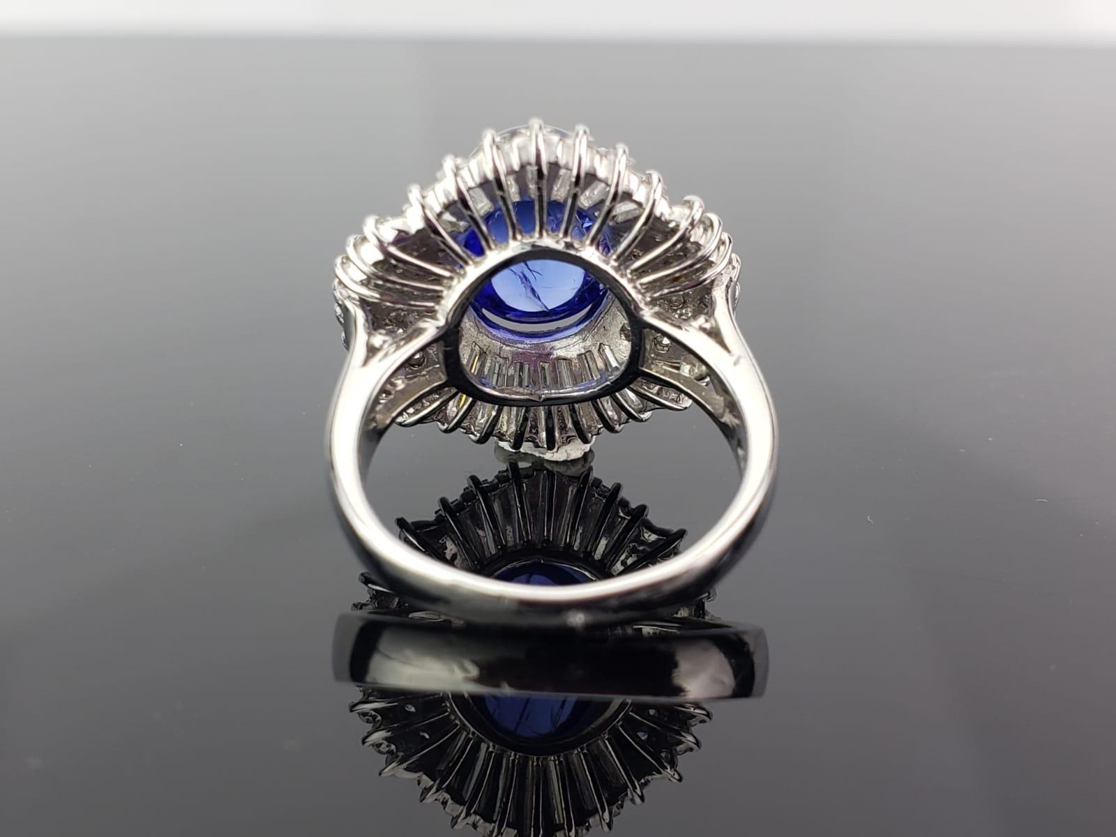 A 5.63 carat Tanzanite Cabochon set in a classic, art-deco looking setting with  1.69 carat Diamond Baguettes and Rounds. The ring is made using 10.45 grams of Platinum. The centre stone is a natural tanzanite, which is absolutely transparent with
