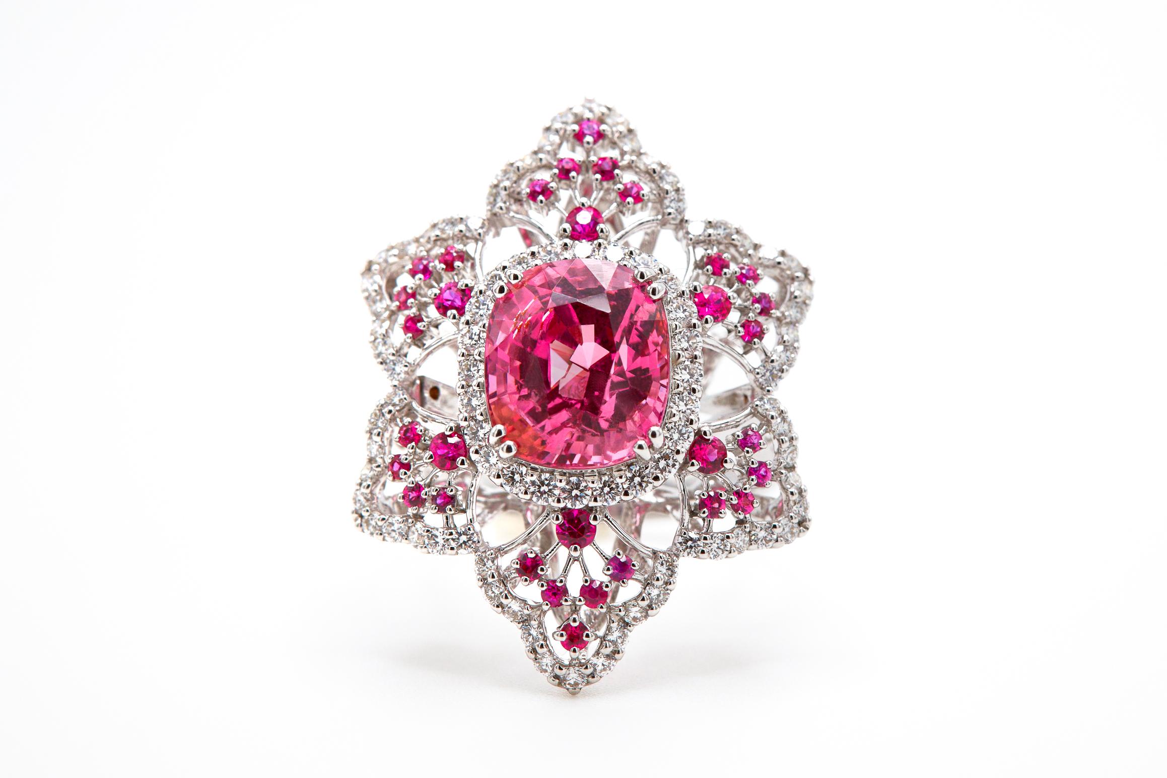 18K WHITE GOLD 
94 DIAMONDS   1.13 CARATS
32 NO-HEAT BURMA RUBIES  0.53 CARATS 
1 NO-HEAT BURMESE PINK SPINEL  5.64 CARATS

Experience unparalleled luxury with our exquisite The Barbie Spinel ring. Featuring a 5.46 carat pink Spinel from Burma, this
