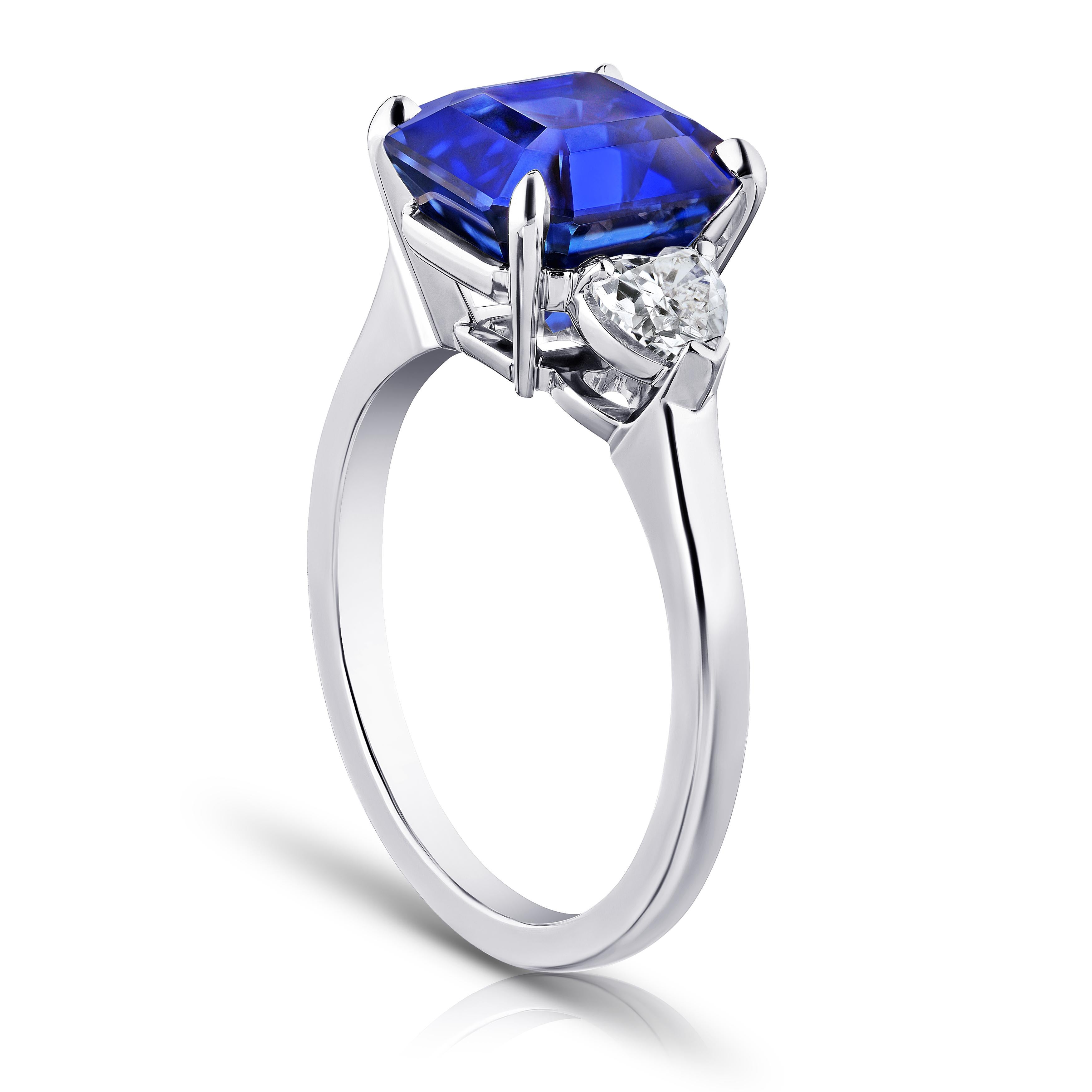 5.65 carat square emerald blue sapphire with heart shape diamonds .58 carats set in a platinum ring Size 7.
