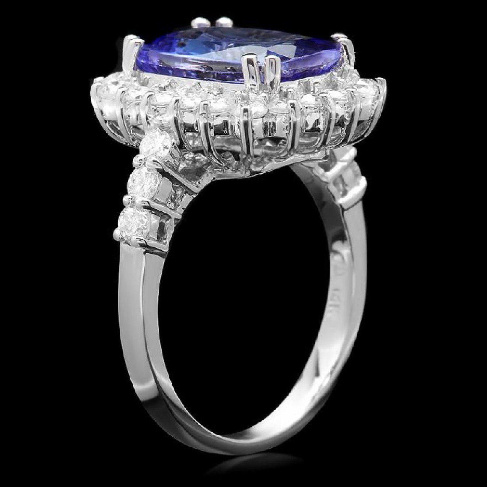 5.65 Carats Natural Very Nice Looking Tanzanite and Diamond 14K Solid White Gold Ring

Total Natural Cushion Cut Tanzanite Weight is: Approx. 4.50 Carats

Tanzanite Measures: Approx. 12.00 x 8.00mm

Natural Round Diamonds Weight: Approx. 1.15 Carats