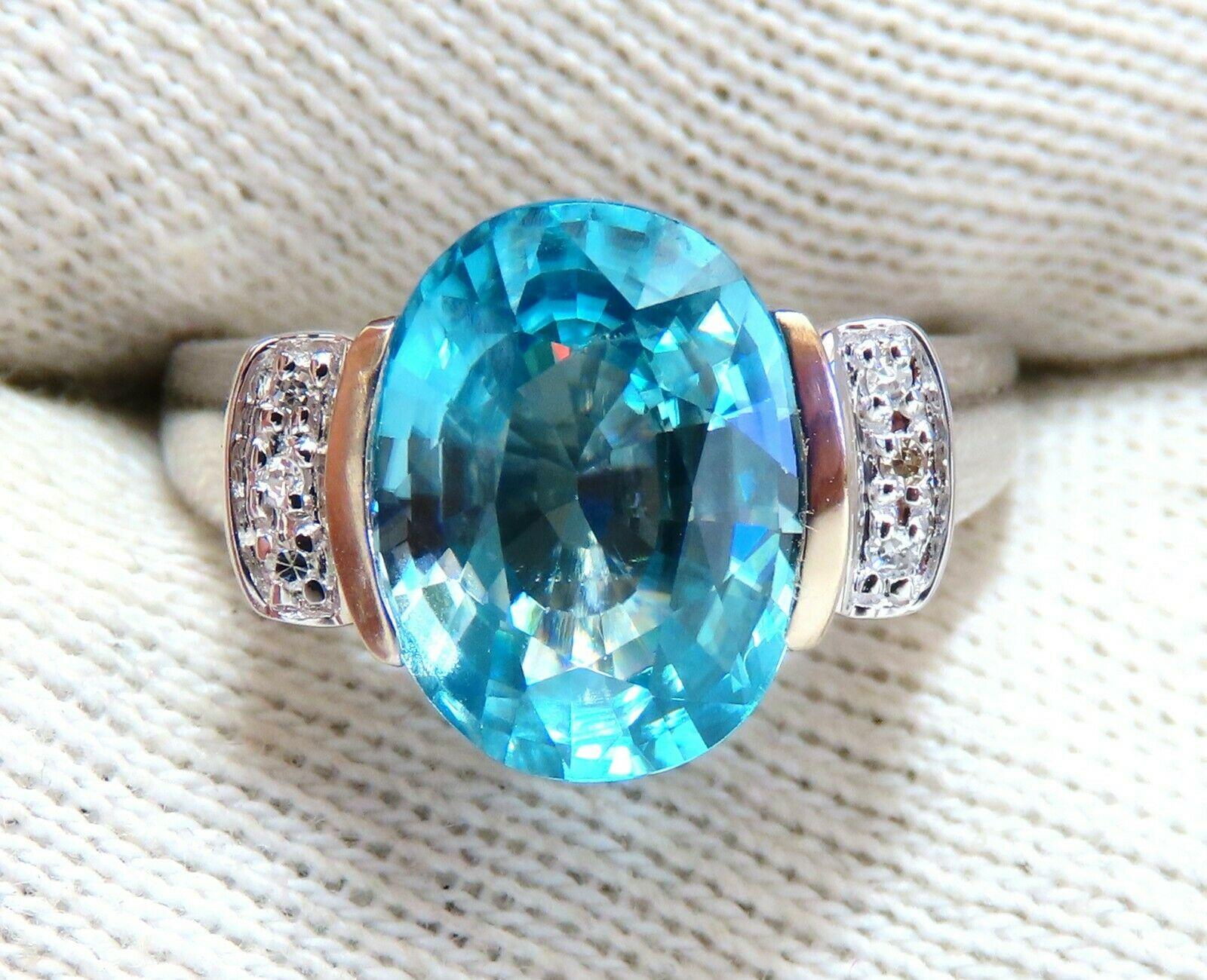 Indigo Blue Natural Zircon Ring

5.65ct. Natural Blue Zircon

Oval cut 11.8 X 8.1mm

 VS Clean Clarity, Transparent

.10ct Side Full cut natural baguette diamonds

 H-colors & Vs-2 clarity

  14kt. white gold

3.9 grams

Ring Current size: