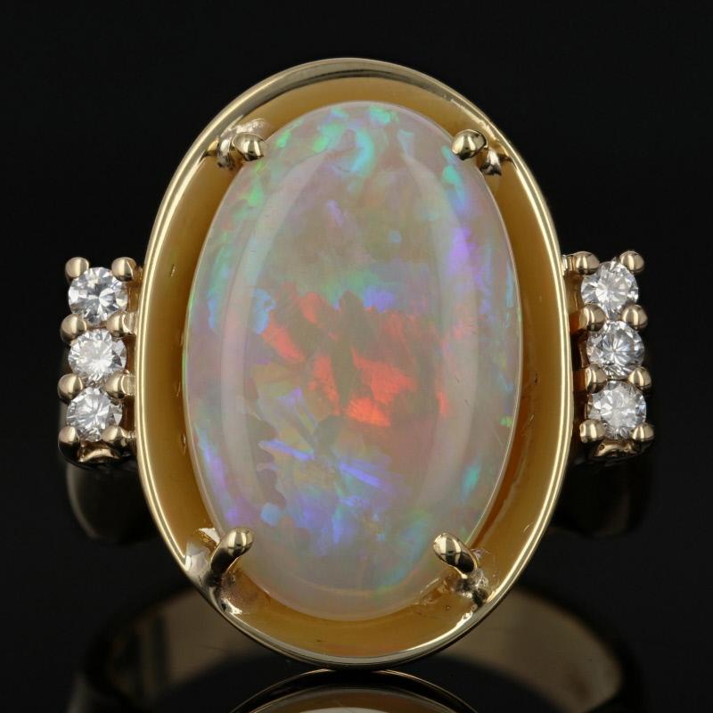 This ring is a size 7.

Metal Content: Guaranteed 18k Gold as stamped

Stone Information: 
Genuine Opal
Cut: Oval Cabochon
Cut: 17.3mm x 11.1mm 
Carat: 5.50ct 

Natural Diamonds  
Clarity: VS1
Color: G - H  
Cut: Round Brilliant 
Carats: