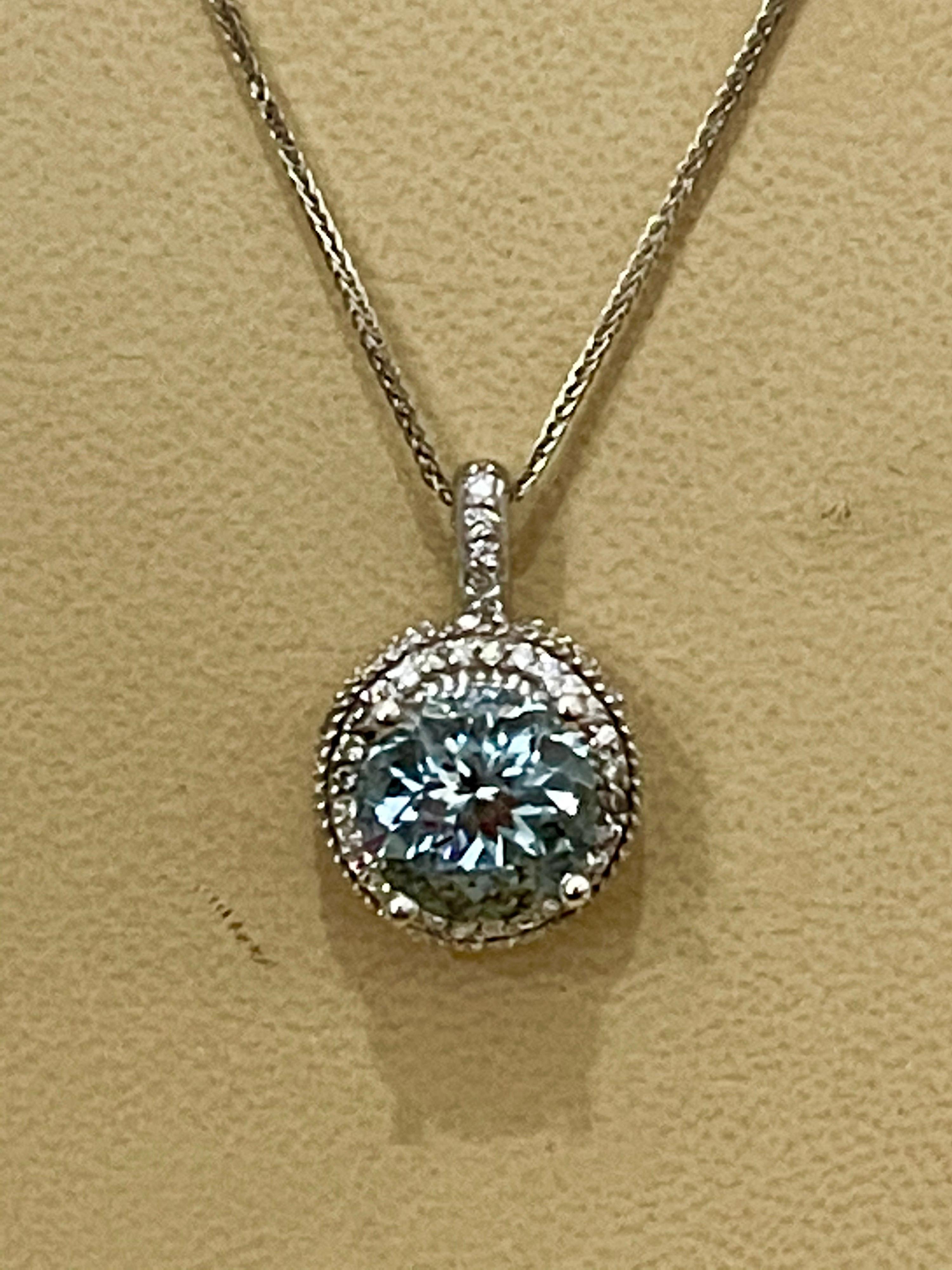 5.66 Carat Aquamarine and 1 Carat Diamond Pendant / Necklace 14 Karat White Gold
This spectacular Pendant Necklace consisting of a single round Shape Aquamarine exactly 5.66 Carat. The Aquamarine size 11.5 MM is surrounded by approximately 1.0