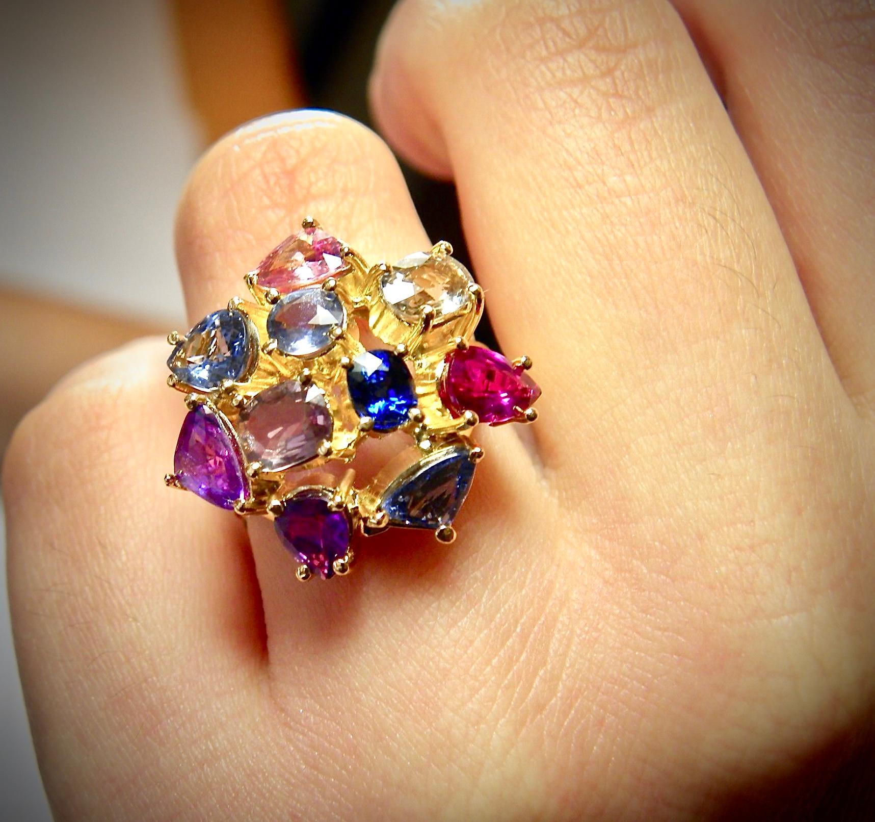 This multi-colored natural untreated sapphire cocktail cluster ring is Just gorgeous! Crafted in 18 Karat Yellow Gold. The featured stones display a spectrum of colors from royal blue to red to pastel pink, and yellow-green.  (total weight of the