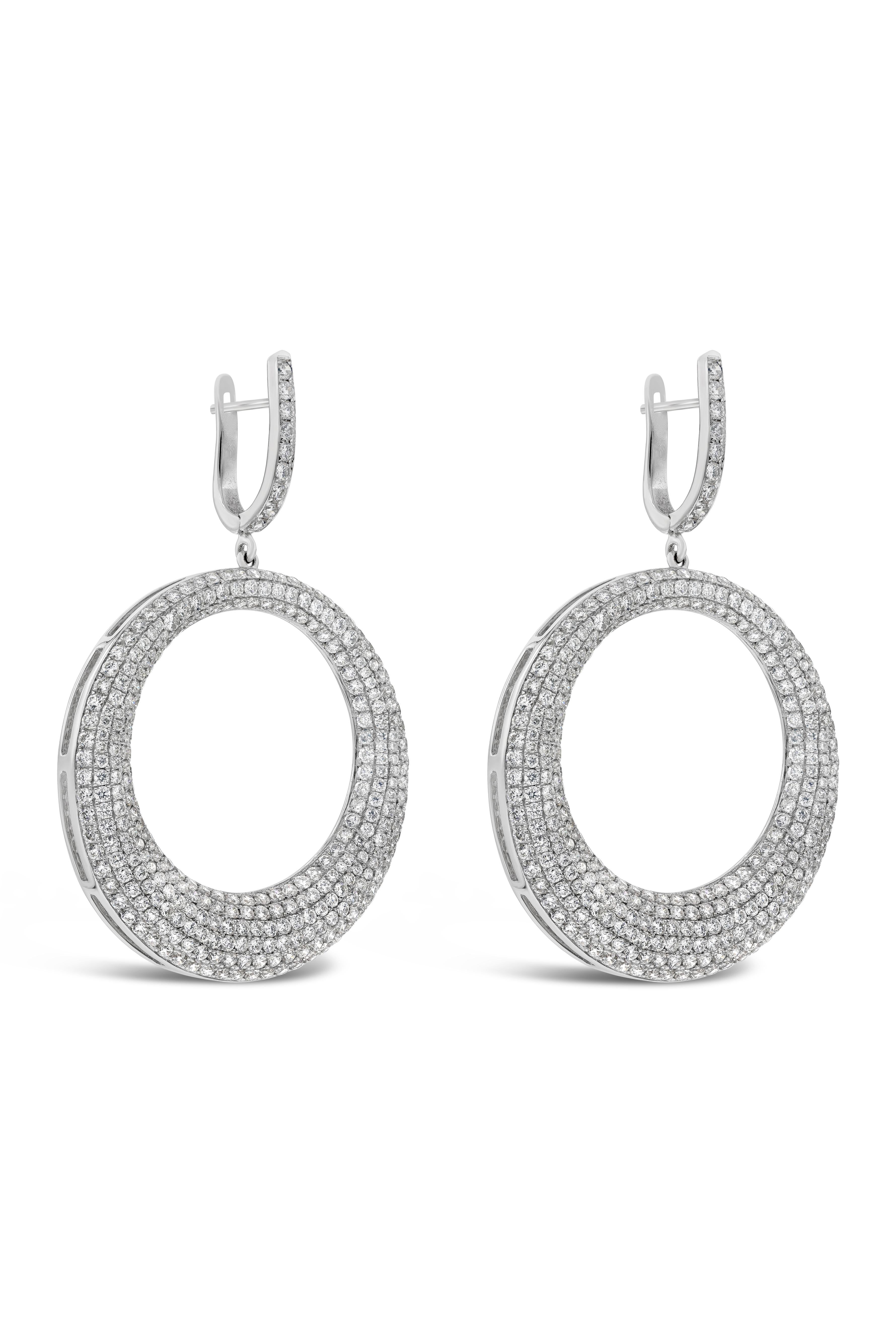 A fashionable pair of dangle earrings showcasing an open-work circular figure, micro pave set with round brilliant diamonds weighing 5.68 carats total. Suspended on a diamond encrusted bale. Made in 18K White Gold. 

Roman Malakov is a custom house,