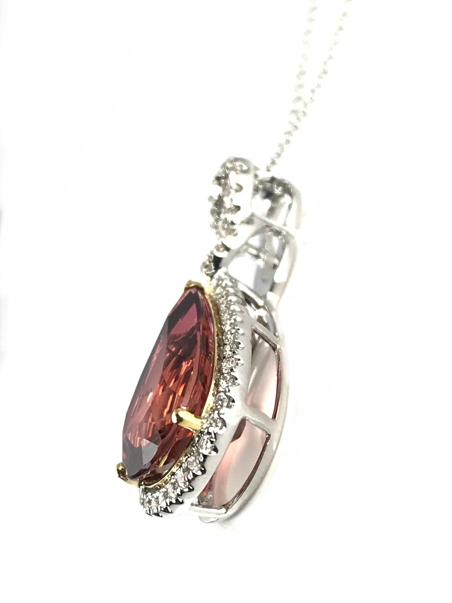At the heart of this pendant lies a 5.68 carat pear-shaped peach tourmaline, a gemstone renowned for its rare and captivating color. The enchanting peach hue is reminiscent of a romantic sunset, casting a warm and gentle glow that is as unique as it