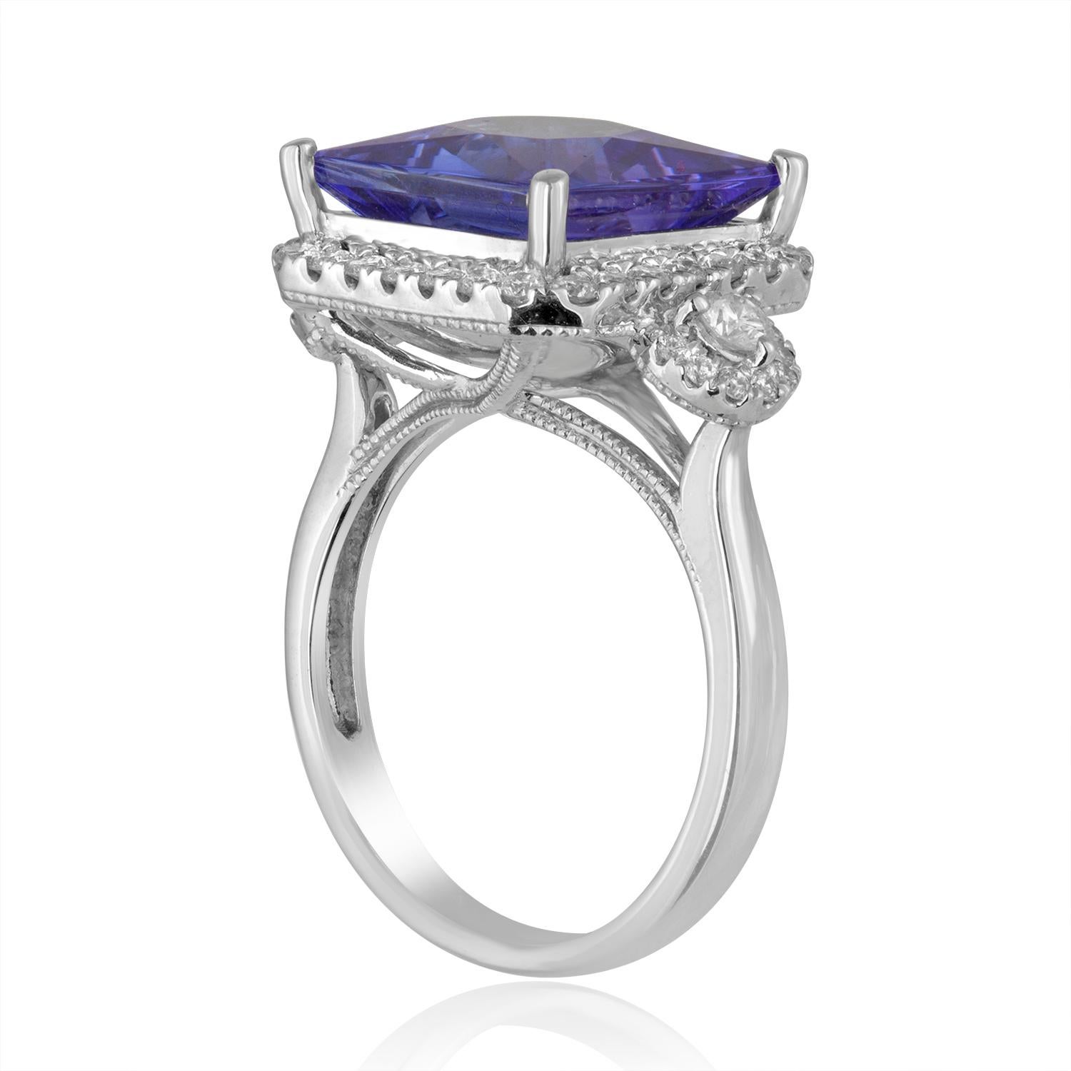 Beautiful Tanzanite Milgrain Ring
The ring is 18K White Gold
There are 0.75 Carats in Diamonds F/G VS/SI
The Tanzanite is Princess Cut 5.68 Carats
The stone with the halo measures 0.50