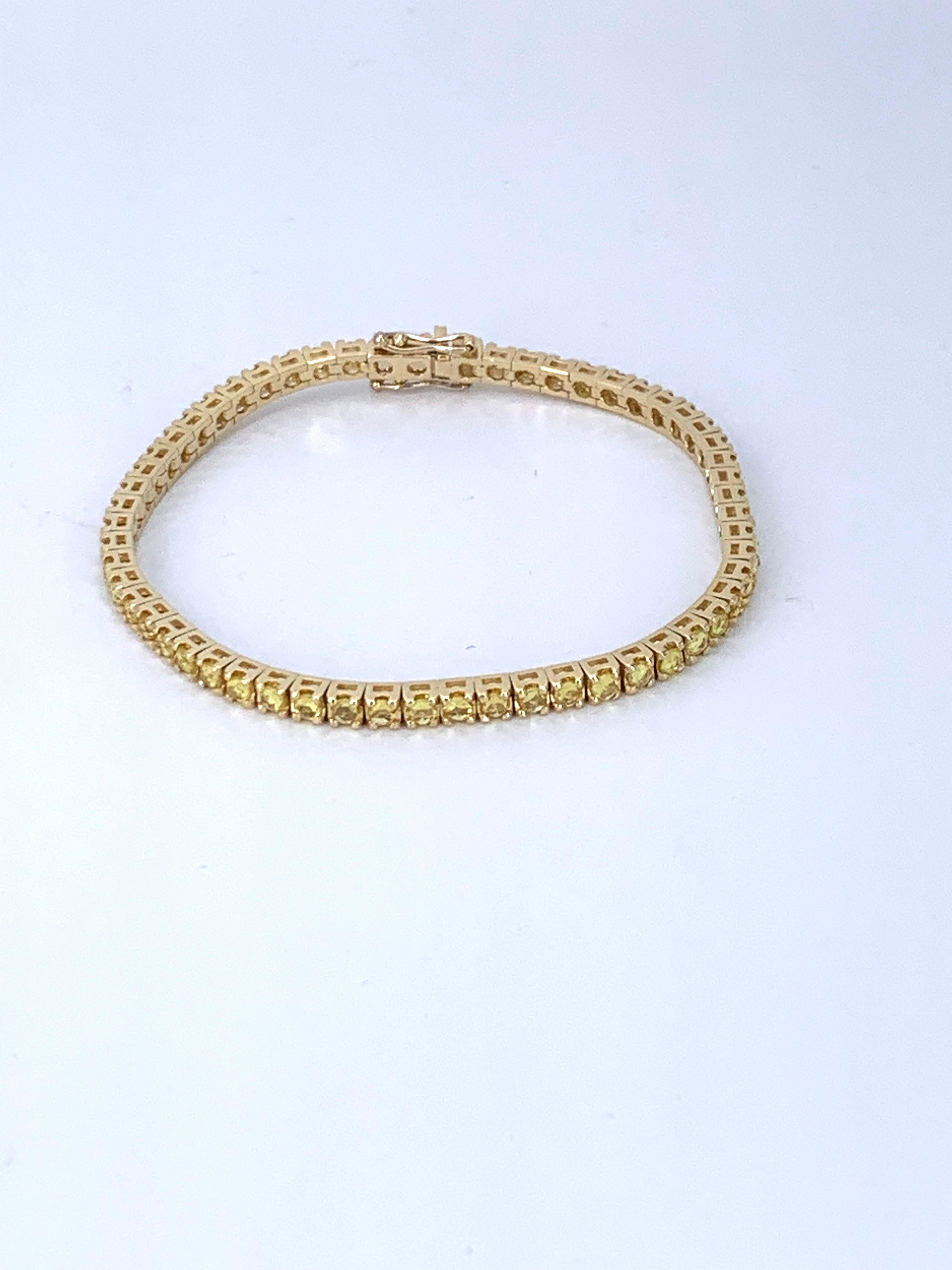 This 5.68 Carat Yellow Sapphire & 18Kt Yellow Gold Unisex Tennis Bracelet, suits any attire whatever the occasion or time of day. 

It beautifully sparkles and can be adored alone or worn stacked with other bracelets. 

Unisex it looks equally