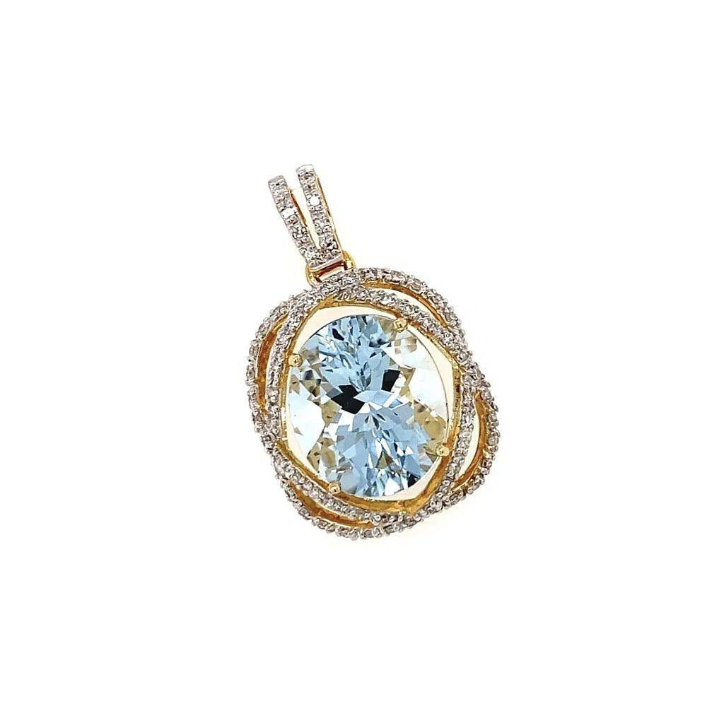 Simply Beautiful! Featuring an Oval Aquamarine Gemstone, weighing approx. 5.59 Carats.  Surrounded by Diamonds, weighing approx. 0.34tcw, securely Hand set in finely detailed Hand crafted intertwined 18K Yellow Gold mounting. Measuring approx. 1.2”.