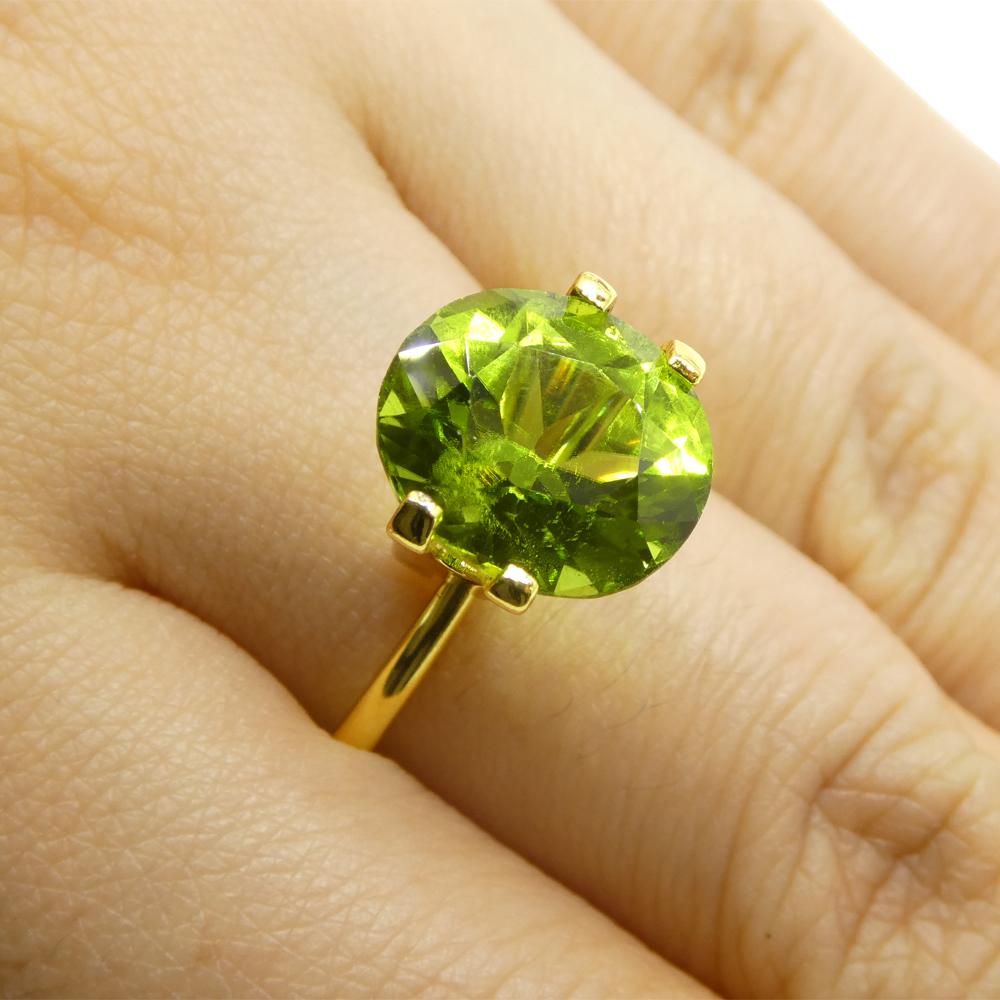Description:

Gem Type: Peridot
Number of Stones: 1
Weight: 5.69 cts
Measurements: 11.74 x 10.20 x 7.25 mm
Shape: Oval
Cutting Style Crown: Brilliant Cut
Cutting Style Pavilion: Brilliant Cut
Transparency: Transparent
Clarity: Very Slightly
