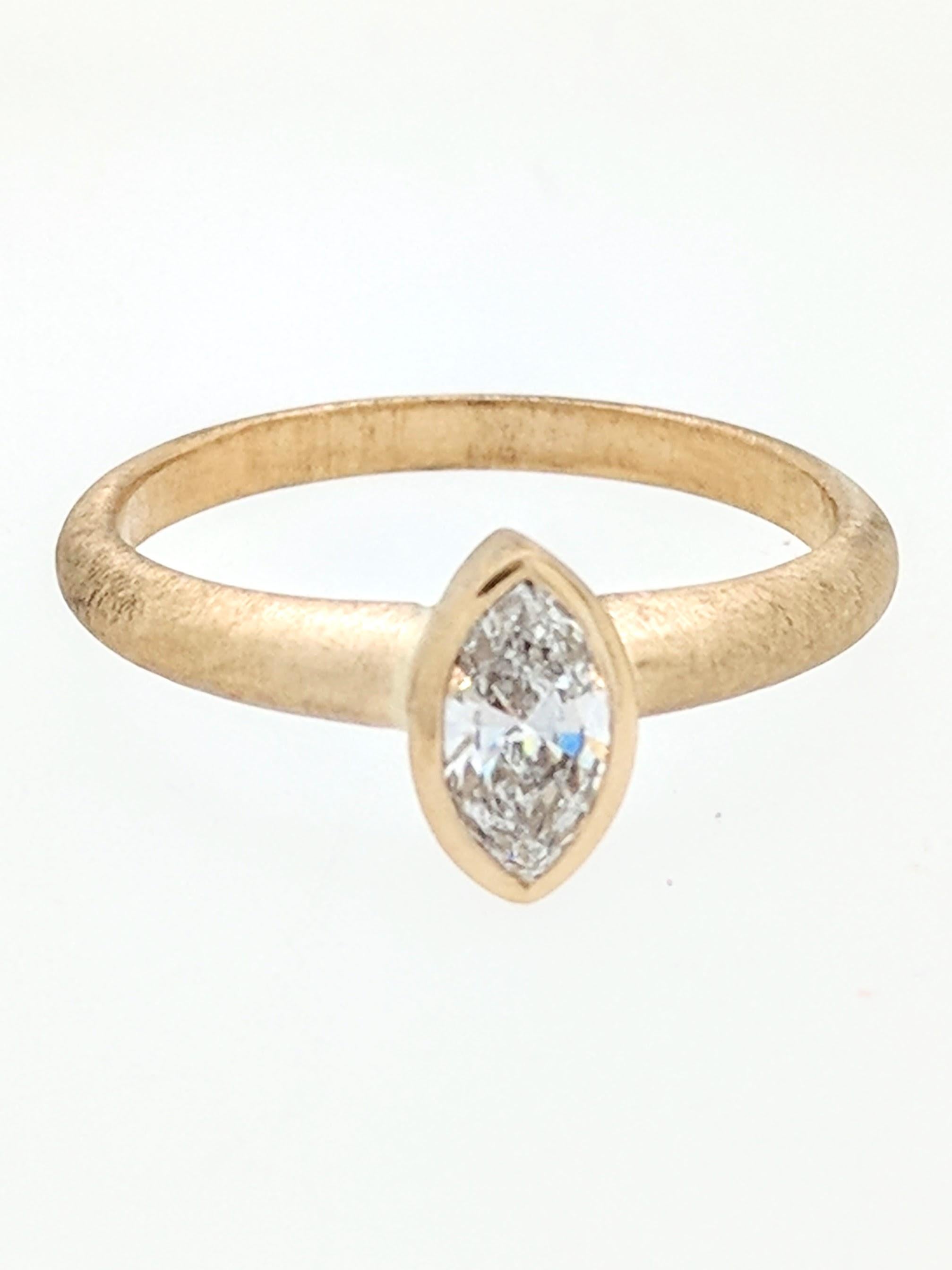 You are viewing a stunning .56ct. natural marquise cut diamond. We estimate this diamond to be SI1 in clarity and G-H color. The diamond is beautifully displayed in a brand new custom made 14kyg bezel set solitaire setting with a matte brushed
