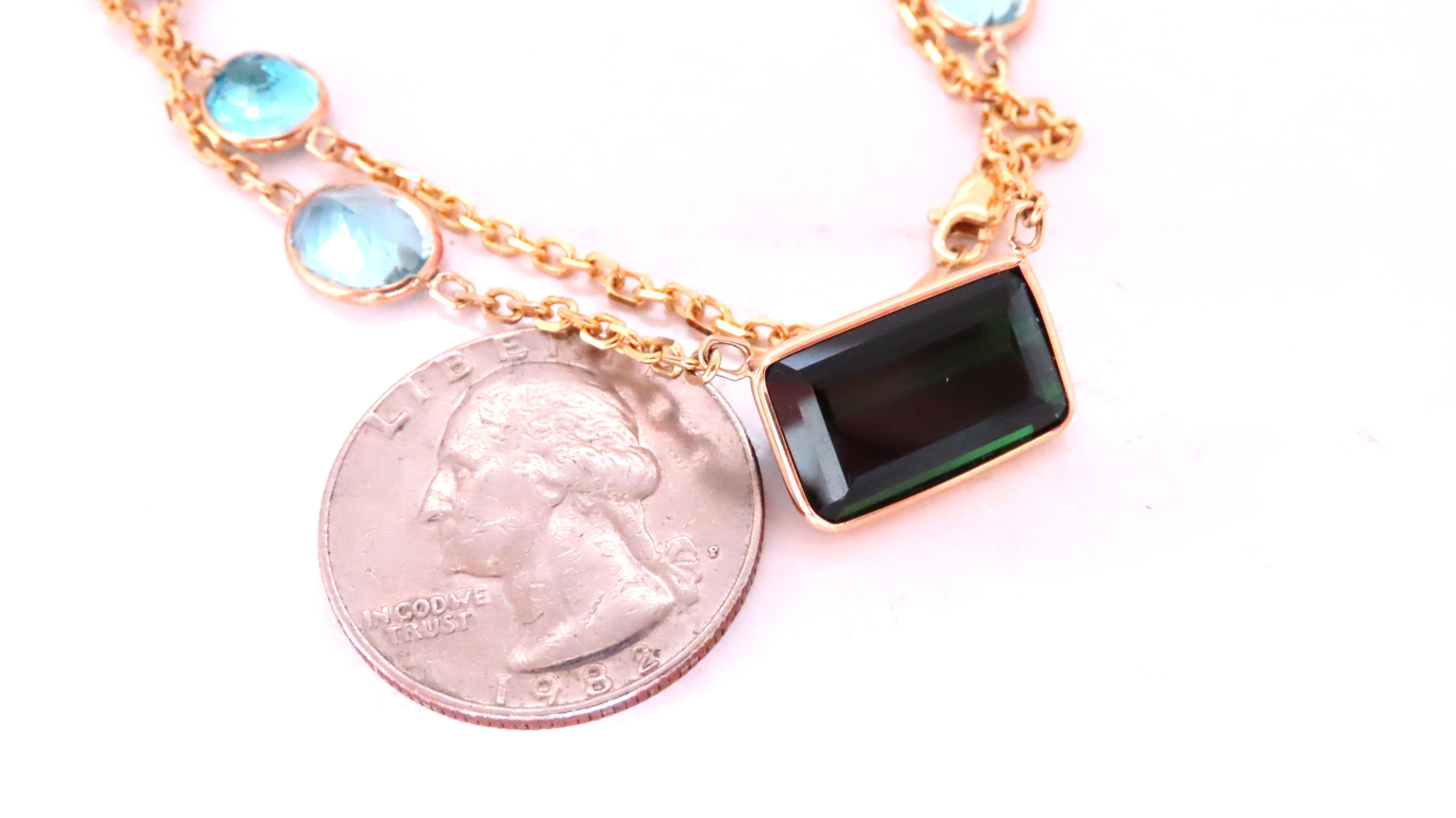 56ct of gorgeous natural gems on chain 
10ct center emerald cut green tourmaline 15 x 9mm 
10ct total weight of natural aquamarines 
7ct total weight of natural amethysts 
8ct total weight of heart peridot
8ct total weight of natural blue zircon
6ct